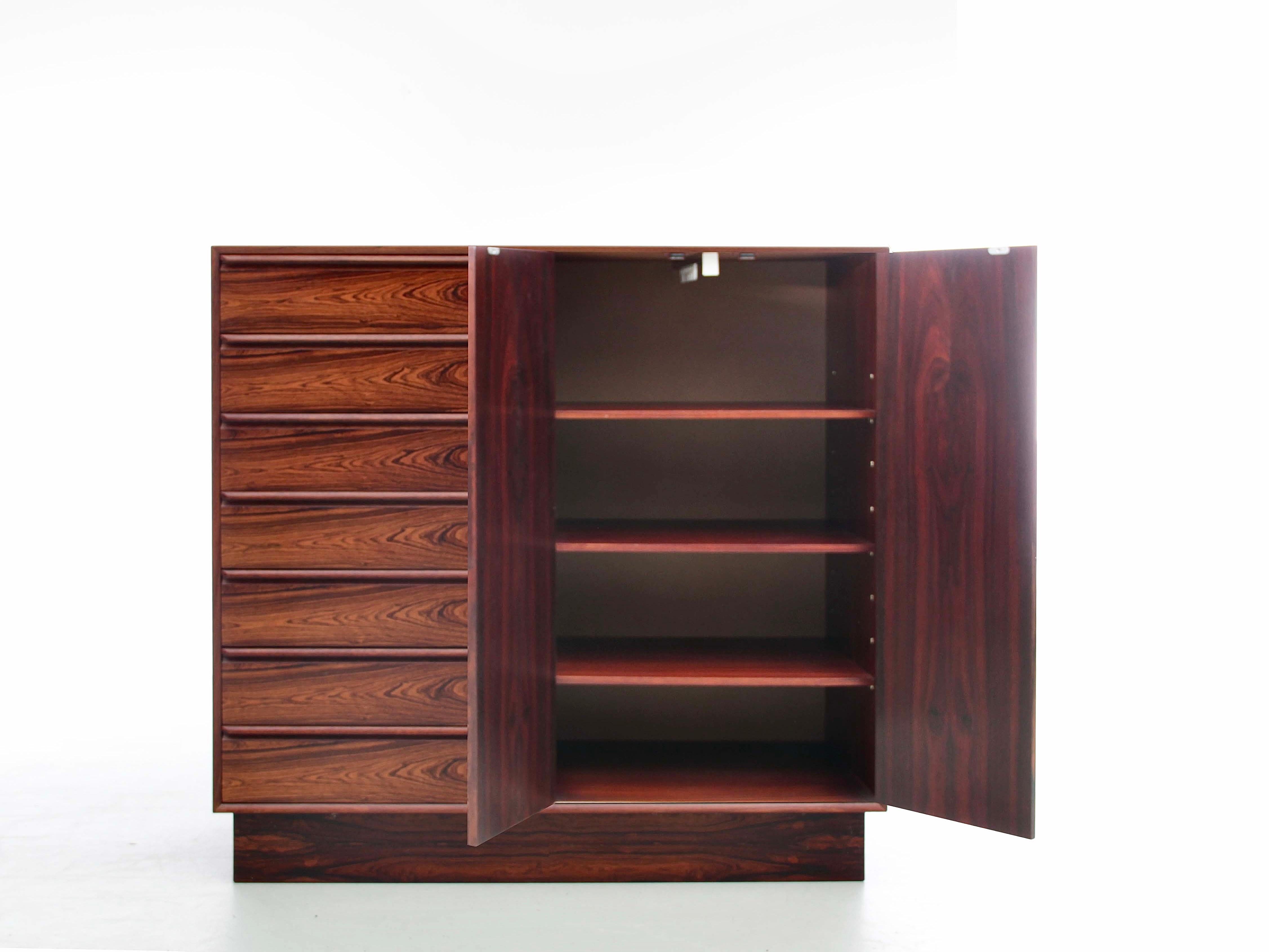Mid-Century Modern Danish chest of drawers and wardrobe. Composing to the left of 7 drawers and to the right of a double door opening on shelves that can be removed or modulated to make a wardrobe with sliding rod.