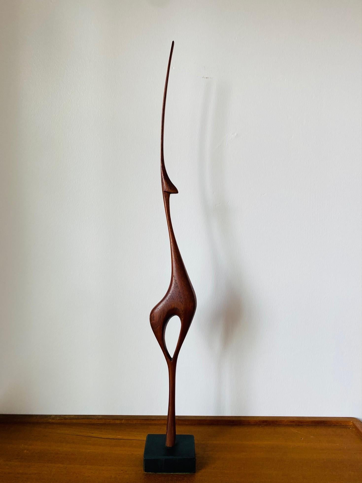 Incredible Mid-Century Modern Danish figure.  This sculptural rendition of a deer in teak is sublime and unique.  The aesthetic profile is polished and slim making this sculpture a classic piece of vintage mid-century art. Tall and commanding, this