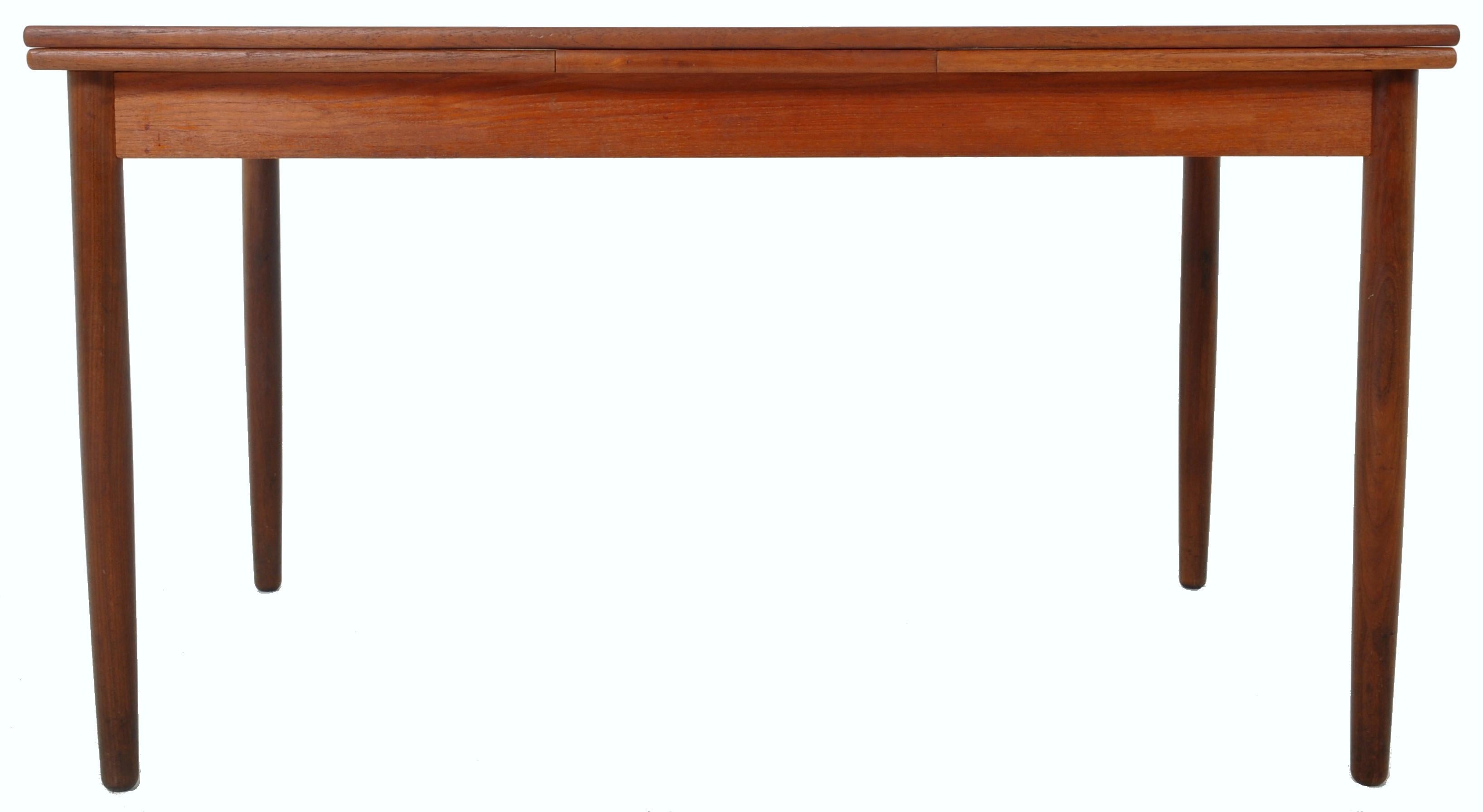 Mid-Century Modern MCM draw leaf dining table in teak, 1960s. The table of rectangular form and having twin draw leaves extending the table to 88