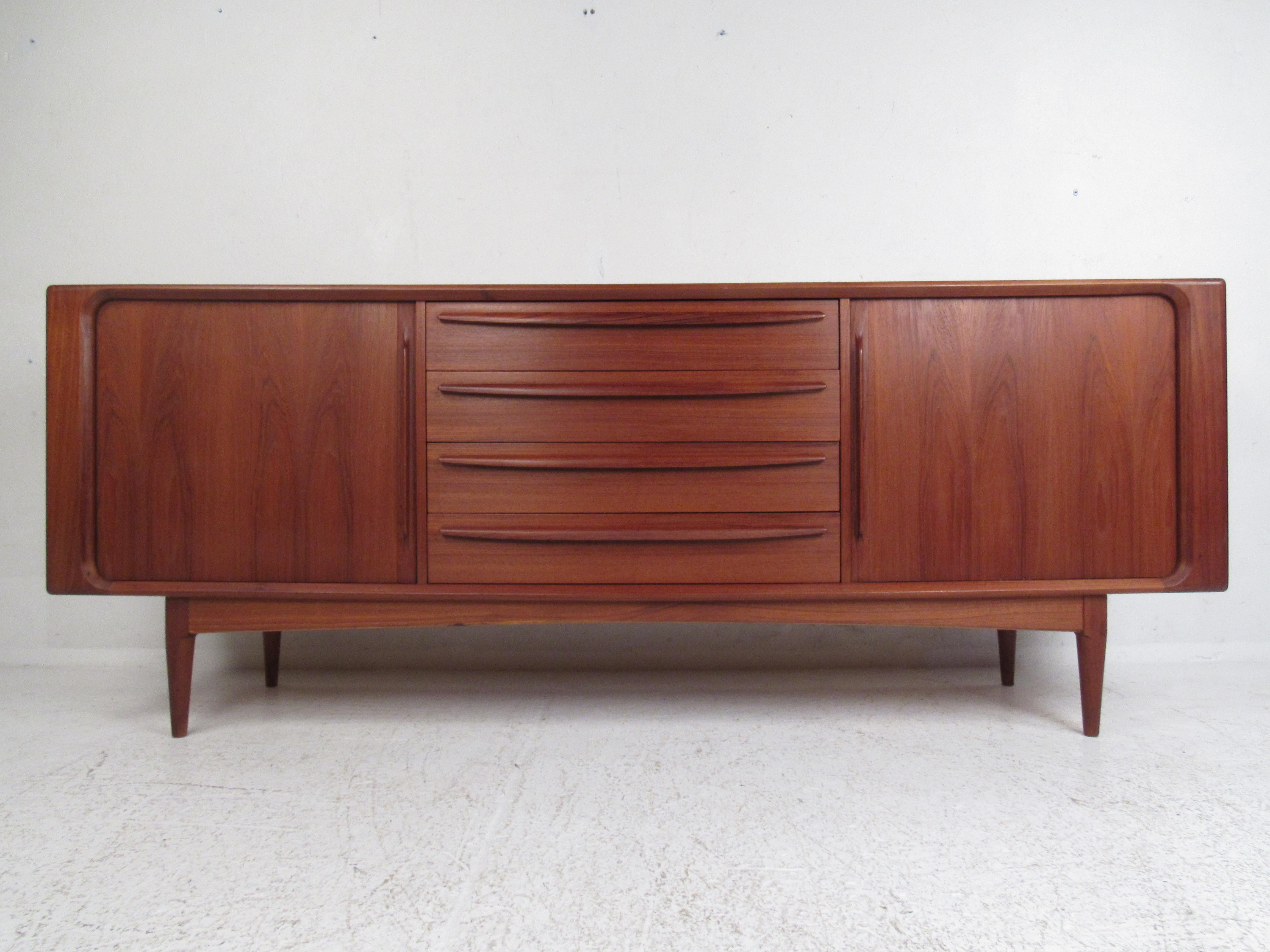 This exquisite vintage modern dresser offers plenty of room for storage within its ten hefty drawers. A unique design that features curved front drawers with dovetail joints, hidden by tambour doors. This stunning Danish modern case piece has a