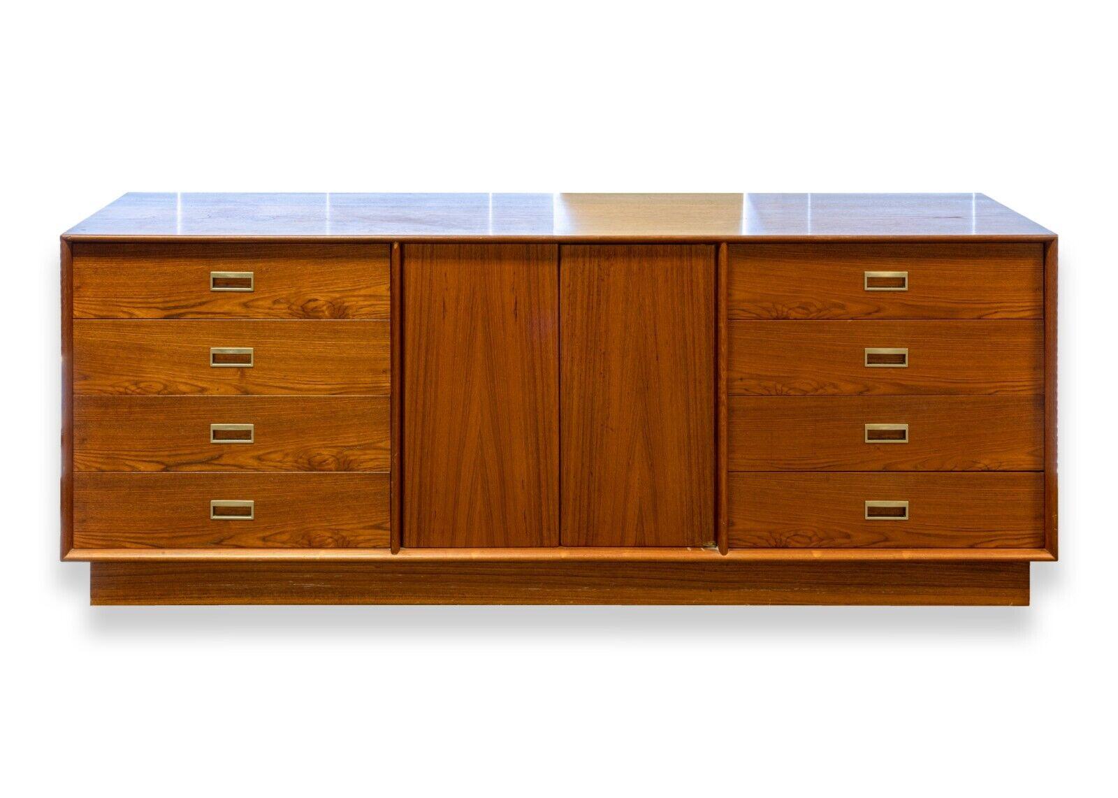 A mid century modern Danish teak wood bedroom set. An amazing bedroom set featuring a highboy dresser, a credenza, a pair of matching mirrors, and a queen headboard. The highboy dresser features 7 pull out drawers with brass handles. The credenza