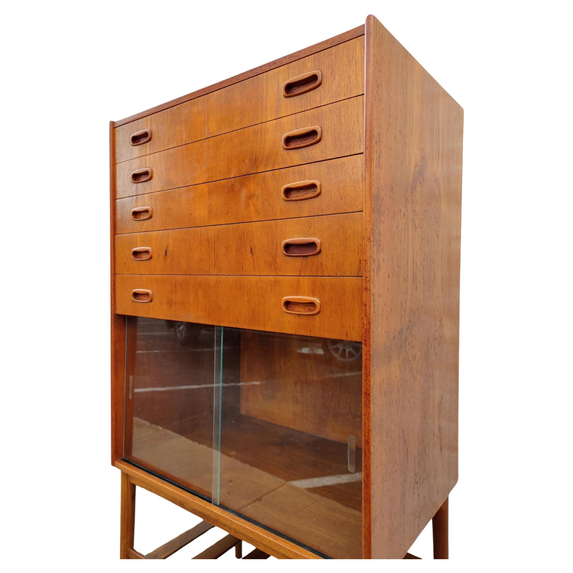 Mid Century Modern Danish Inspired Teak Cabinet

Above average vintage condition and structurally sound. Has some expected slight finish wear, dark blemishes and scratching. Please request additional pictures. 

Additional information:
Materials: