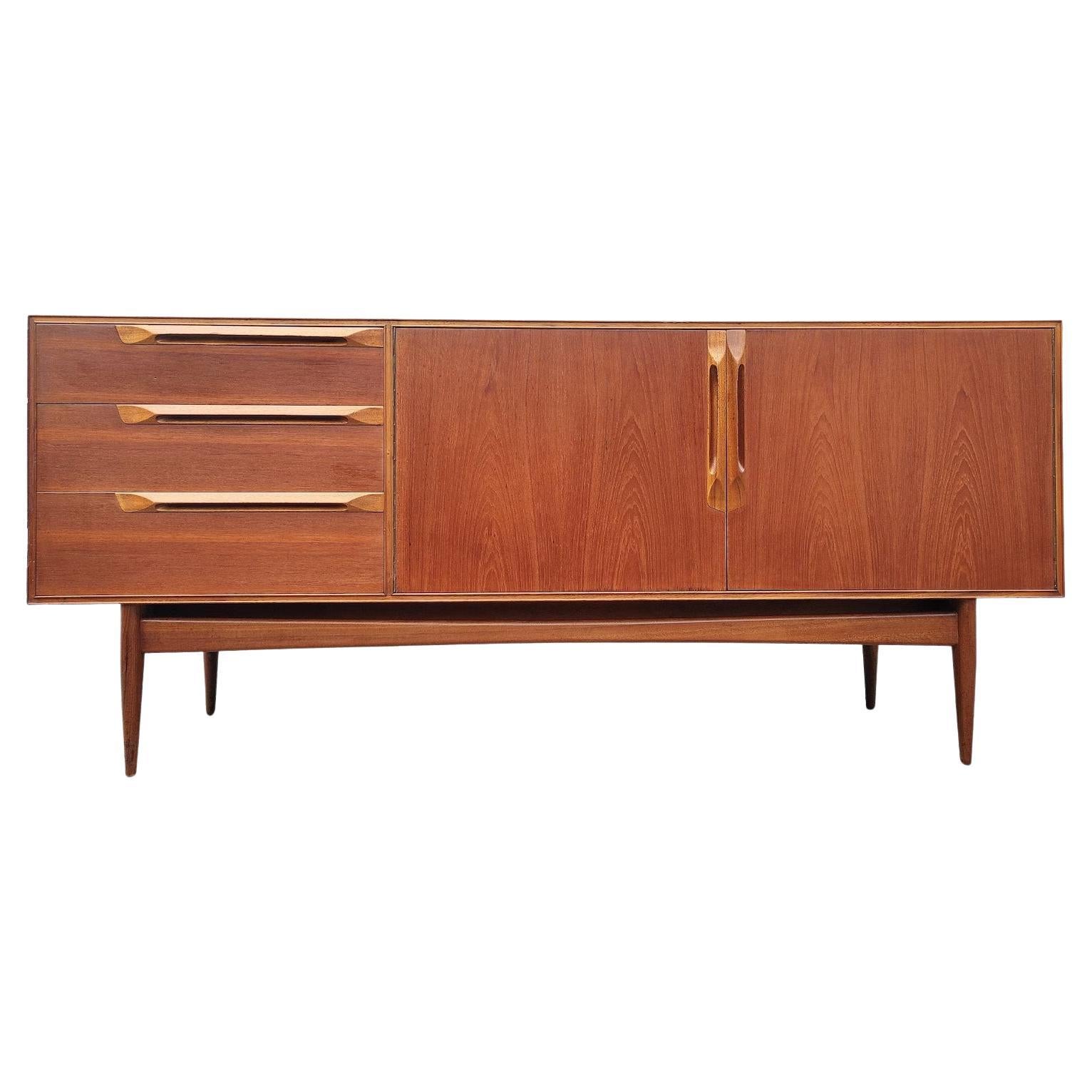 Mid Century Modern Danish Inspired Teak Credenza by McIntosh 

Above average vintage condition and structurally sound. Has some expected slight finish wear and scratching. Edges have some dings and small chips. Please see listing pictures. Outdoor