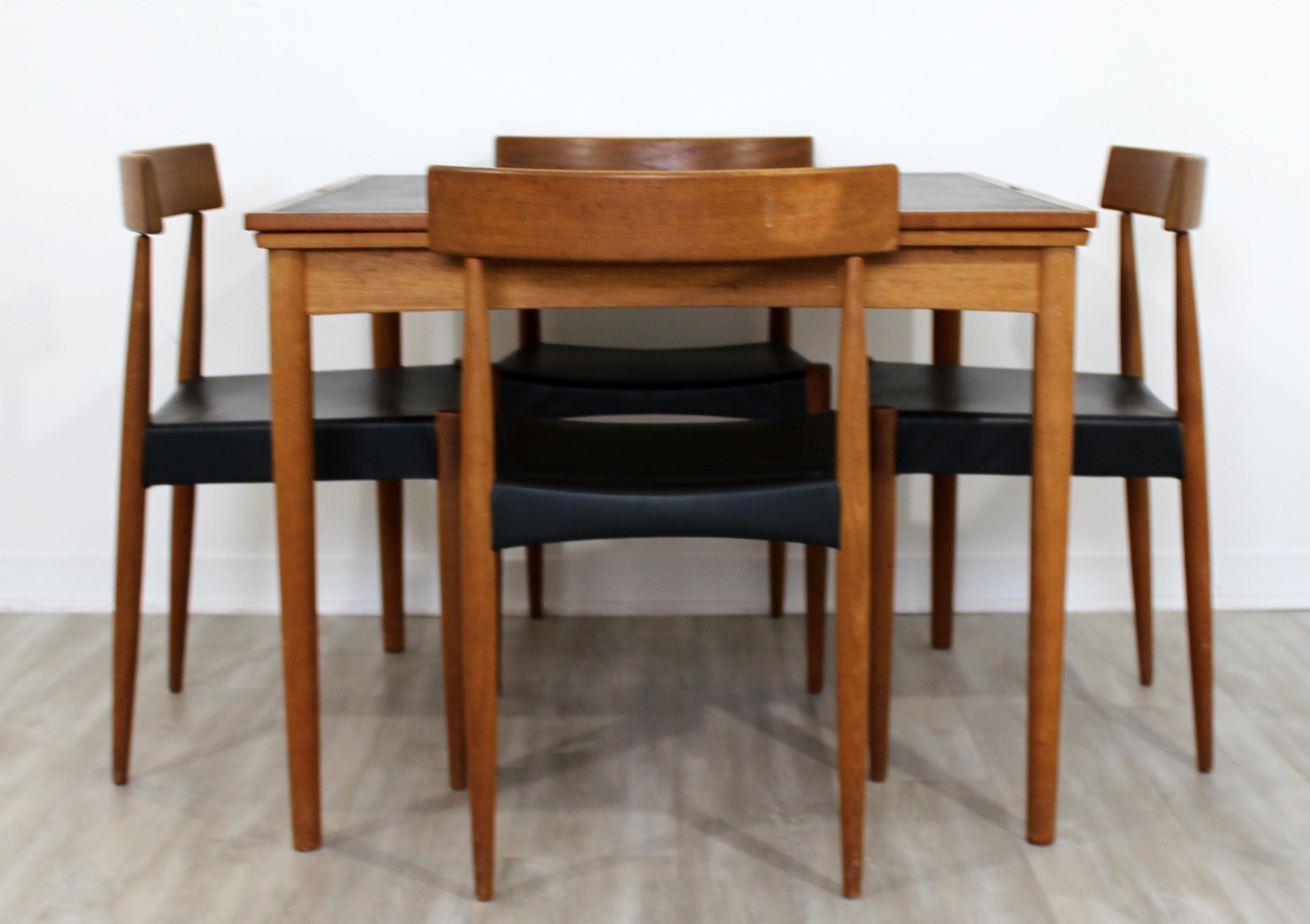 For your consideration is a fantastic dining set, including expandable leather topped table and four side dining chairs, made in Denmark, circa 1960s. In excellent vintage condition. The dimensions of the table are 35