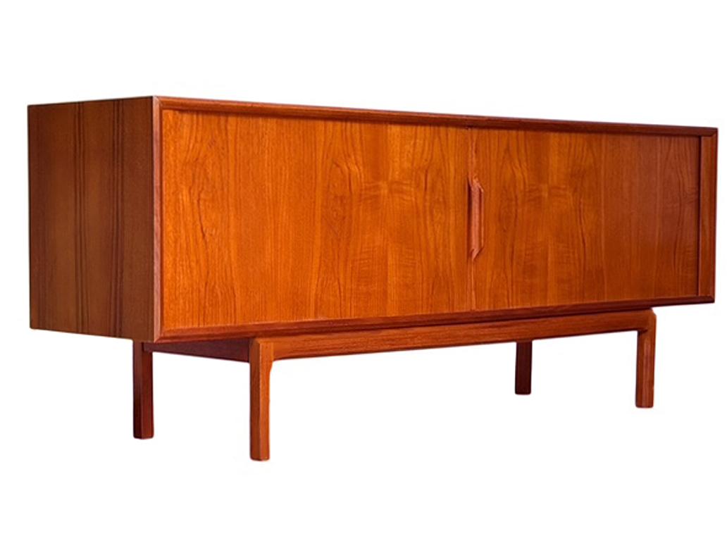 A beautifully designed teak credenza with top notch construction made by Kai Kristiansen and produced by Faarup in the 1960's. It features a sleek full front tambour door with tons of interior storage. Super clean and ready to use condition. 
