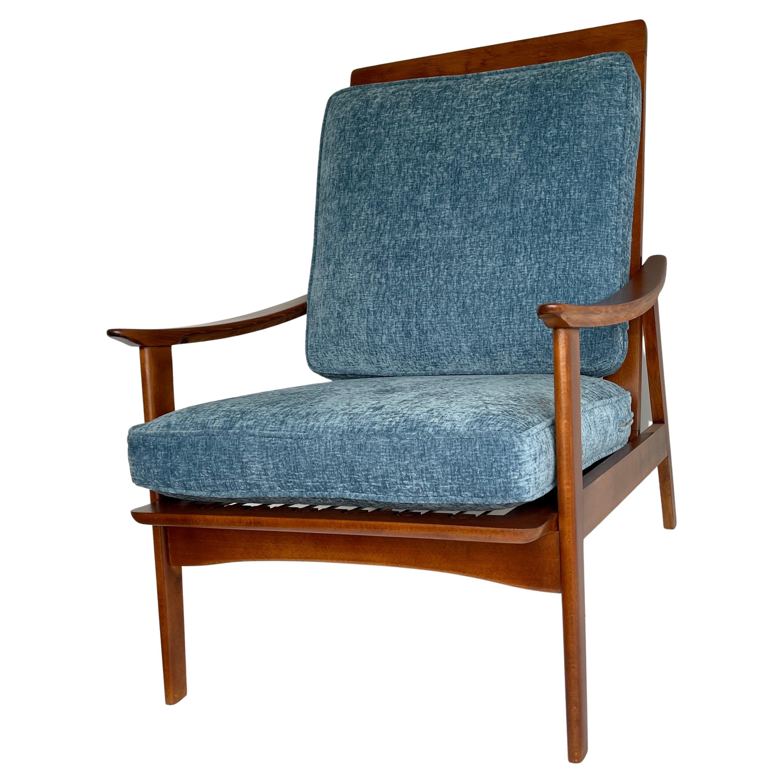 Mid-Century Modern lounge chair designed by Peter Hvidt & Orla Mølgaard-Nielsen for France & Daverkosen in Denmark in the 1950s. Newly restored, the walnut frame bears it's original beauty. Backrest with seven spindles and the seat rest features