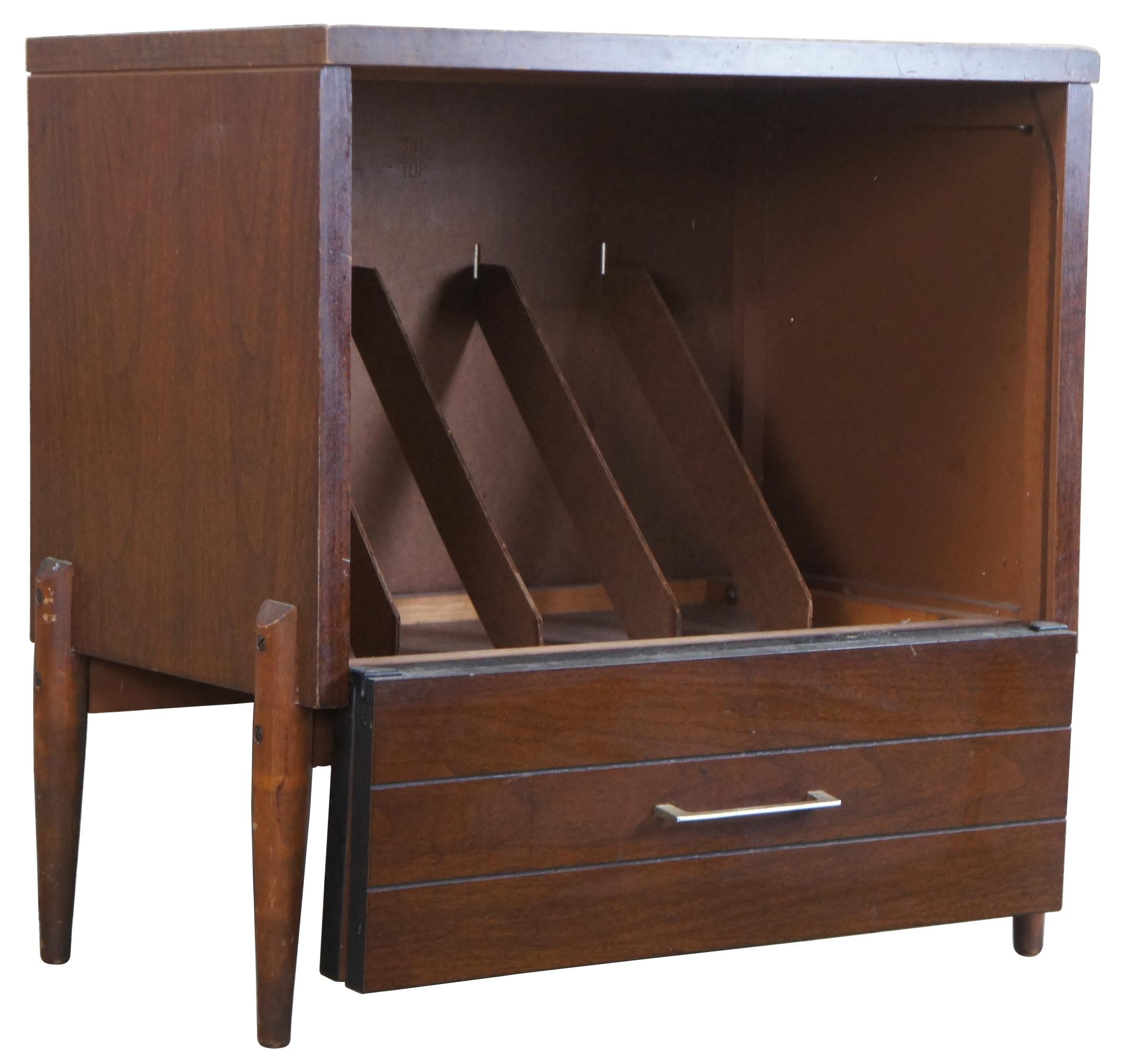 Danish mid century vinyl record or music cabinet by Lu Van Inc. Made of oak featuring a folding cabinet door that leads to four interior dividers over tapered legs.
 