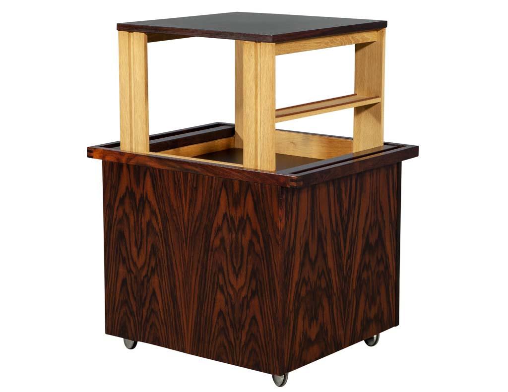 Mid-Century Modern Danish pop up bar table cabinet. Modern sleek Danish table with a concealed bar storage compartment that lifts up and reveals a functional laminate top for practical use. Classic midcentury design from the 1960s Europe.

Closed: