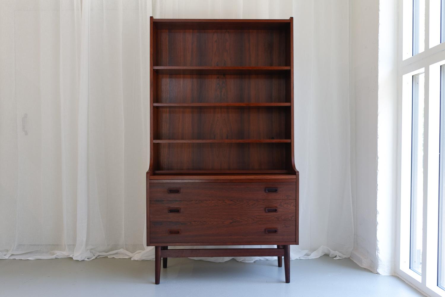 Mid-Century Modern Danish rosewood bookcase, 1960s.

This Classic Scandinavian bookcase was designed by Danish master carpenter Johannes Sorth for Nexø Møbelfabrik, Bornholm, Denmark in 1956. The idea was to combine a cabinet and a book case, and it