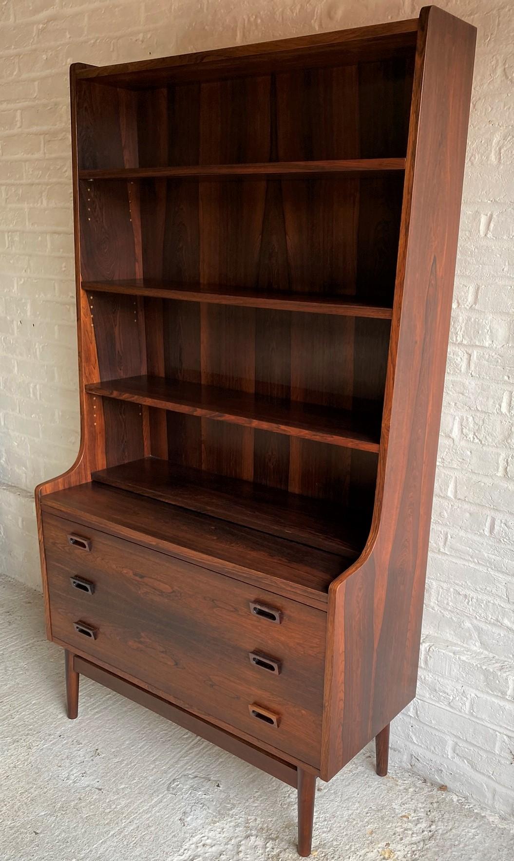 Mid-Century Modern Danish rosewood secretaire bookcase by Johannes Sorth, 1965

This stunning Rosewood Secretaire / bookcase was designed by Johannes Sorth in Denmark in the 1960s and manufactured by Bornholm Møbelfabrik. 
The top half of the unit