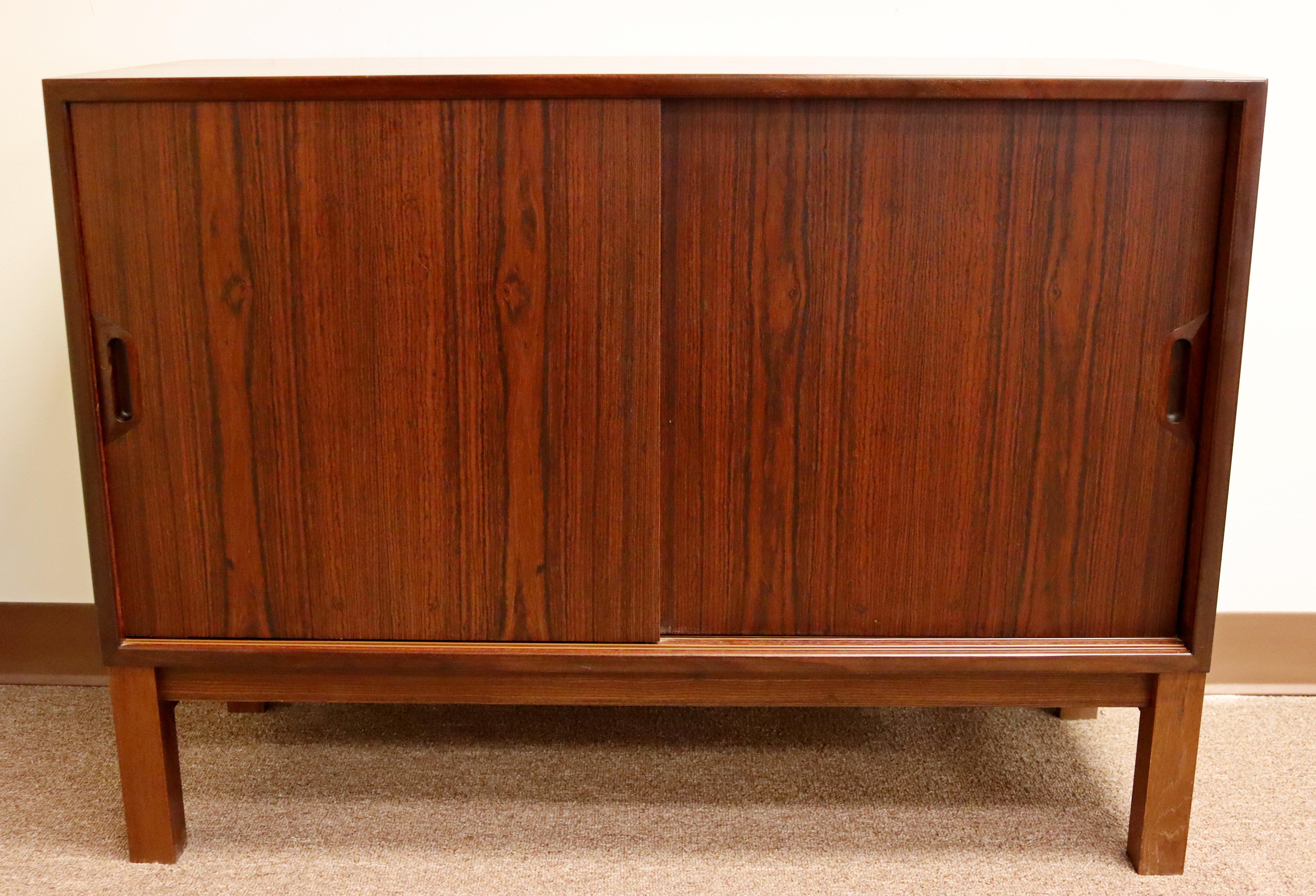 For your consideration is a fantastic, short credenza or cabinet, made of rosewood and with sliding doors, made in Denmark, circa the 1960s. In excellent vintage condition. The dimensions are 39.5
