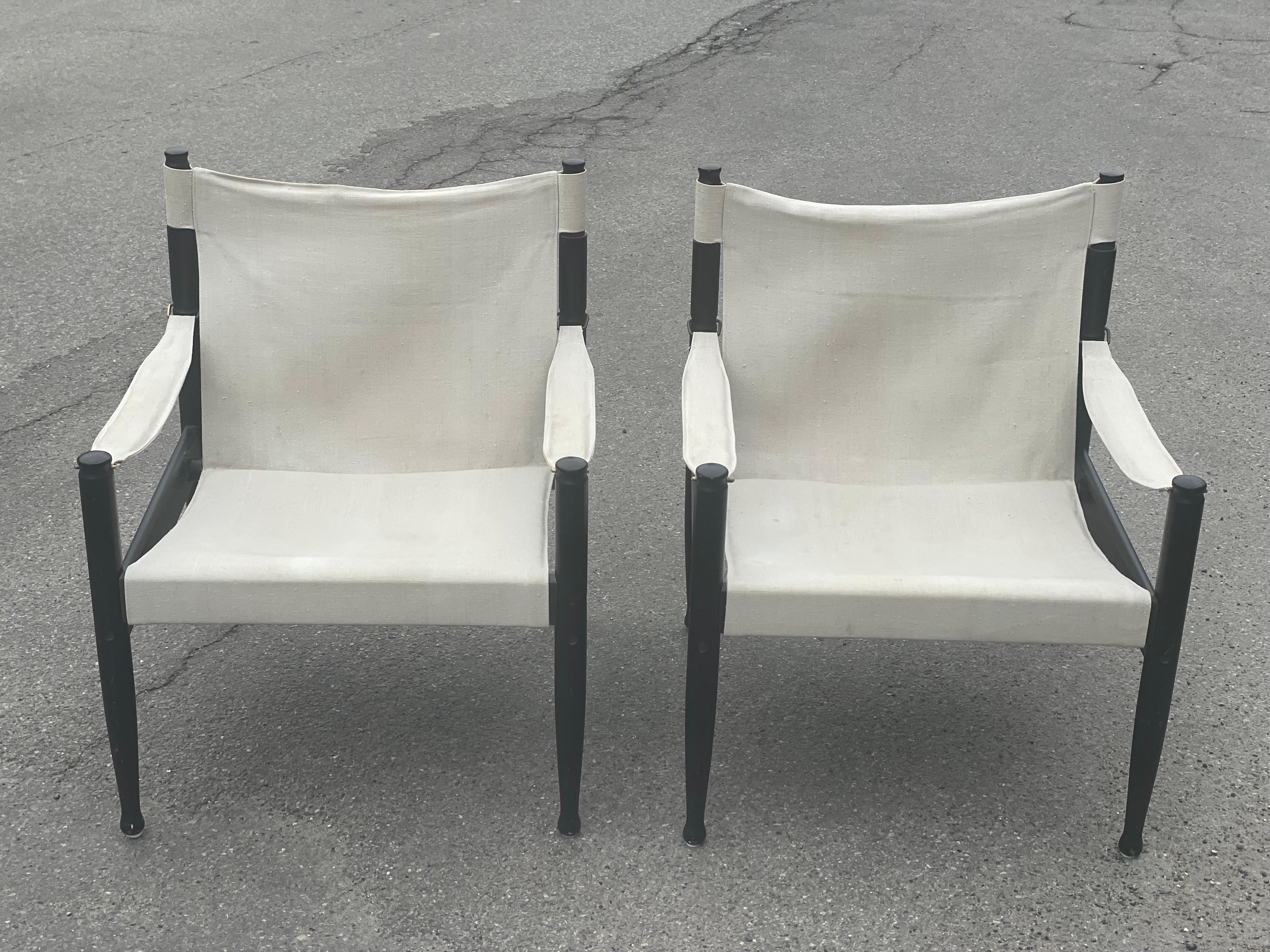 Looking for the perfect blend of comfort and style in your home decor Look no further than these exquisite safari lounge chairs by Erik Worts for Niels Eilersen. With their sleek black enamelled frames and durable canvas upholstery, these chairs