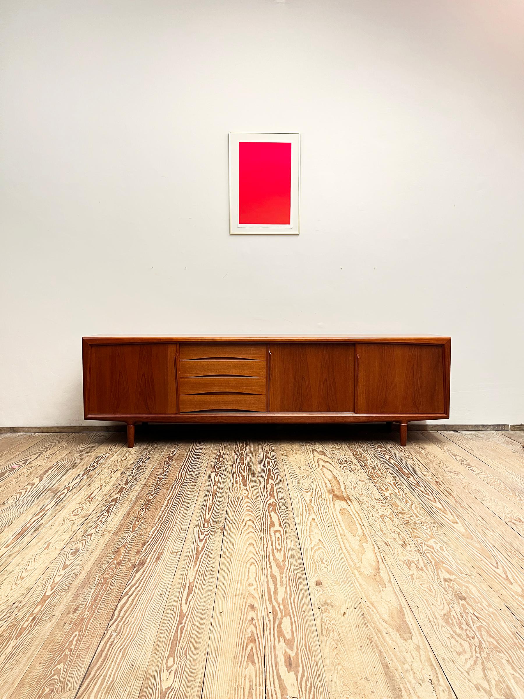 Dimensions: 240x47x80 cm (Width x Depth x Height)

This Scandinavian mid century modern teak credenza was manufactured in the 1950s by Axel Christensen Odder or ACO in Denmark.

It shows exquisite Danish craftsmanship and offers plenty of storage