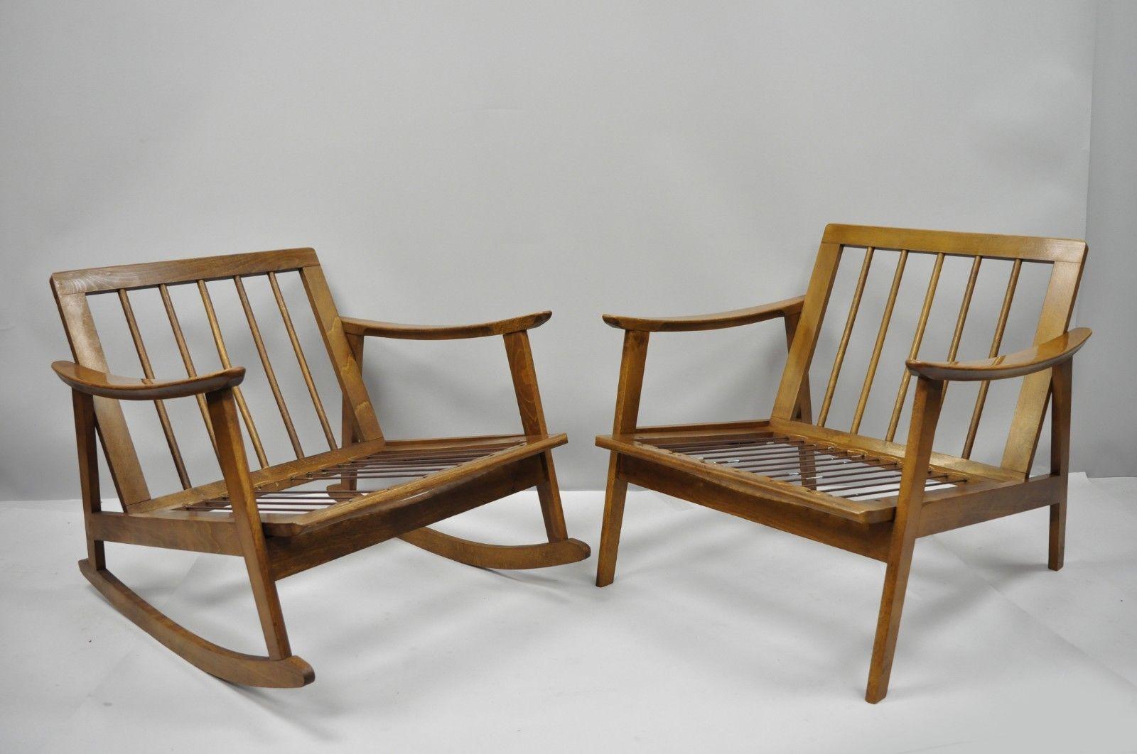 Vintage complimenting pair of Mid-Century Modern Danish style lounge chairs (One Rocker and one Armchair). Item features one lounge chair, one rocking chair, spindle back, reversible zip-off cushions, solid wood frame, beautiful wood grain, tapered