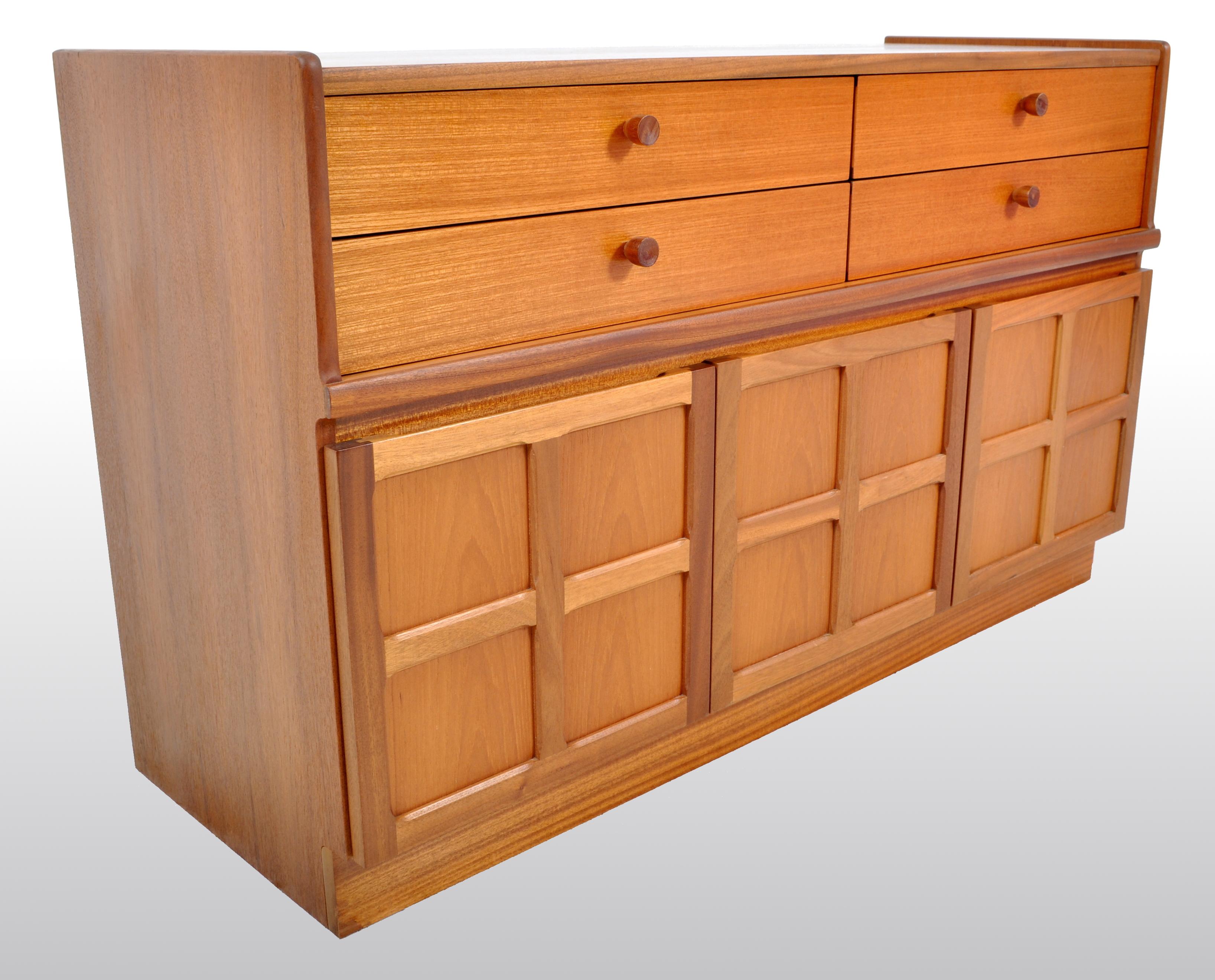 Mid-Century Modern Danish style cabinet in teak by Nathan Furniture, 1960s. The cabinet having twin banks of two drawers above three paneled cupboard doors. The cabinet standing on a plinth base.