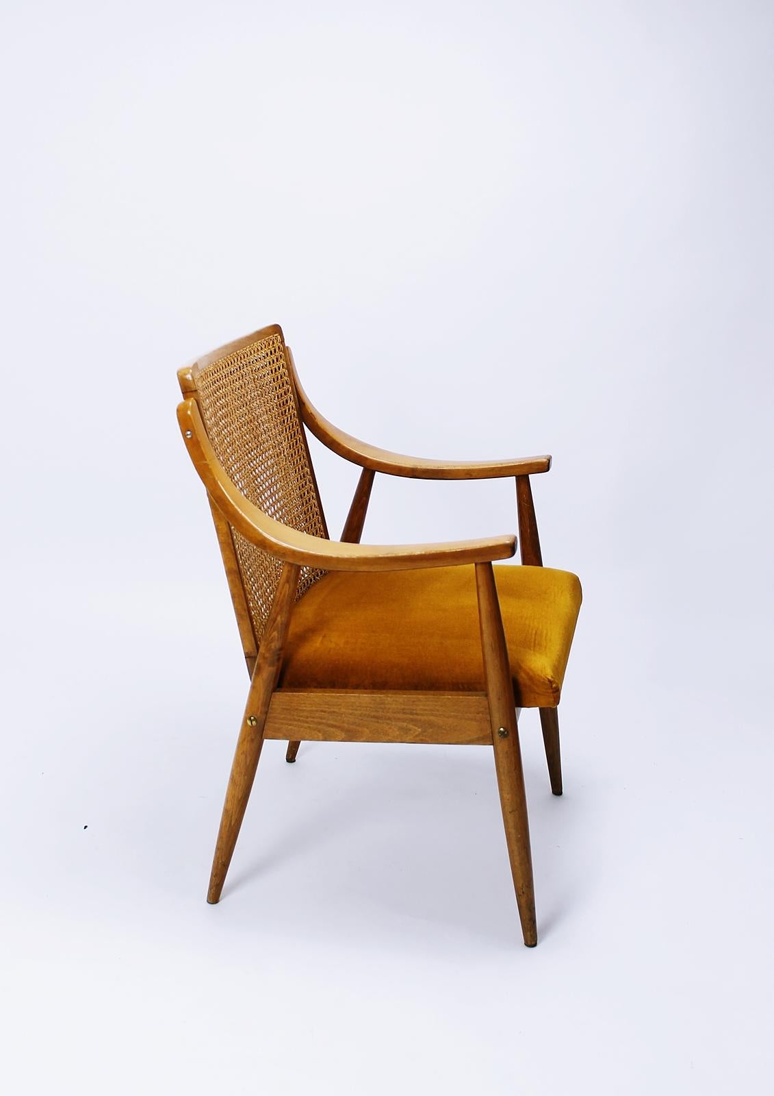 Gorgeous, sculptural Midcentury Hungarian armchair in oak with caned back in style of Peter Hvidt and Orla Mølgaard-Nielsen, circa 1960. Chair is signed with the typical metal tag of MSZMP. Warm, rich patina and in very good original condition.