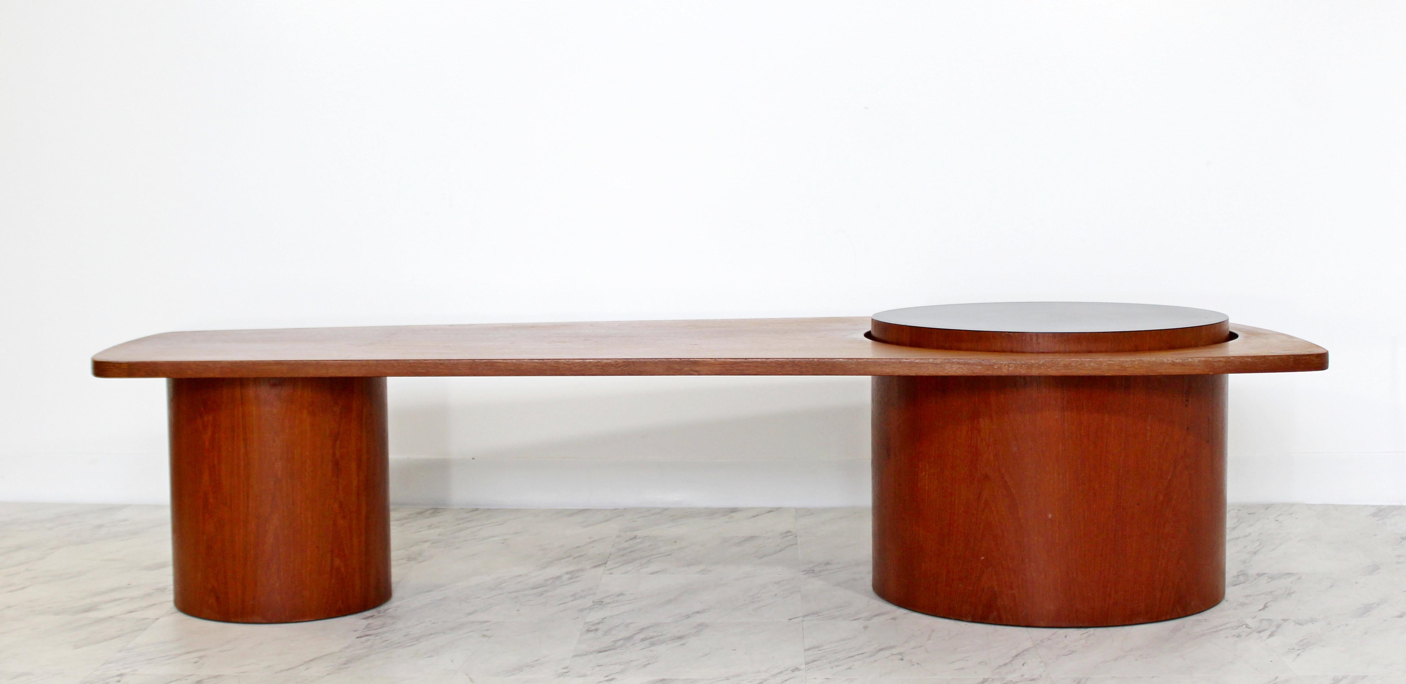 For your consideration is a stunning, long coffee table, with a free-form teak design and round bases, in the Danish style, circa the 1960s. In very good condition. The dimensions are 67