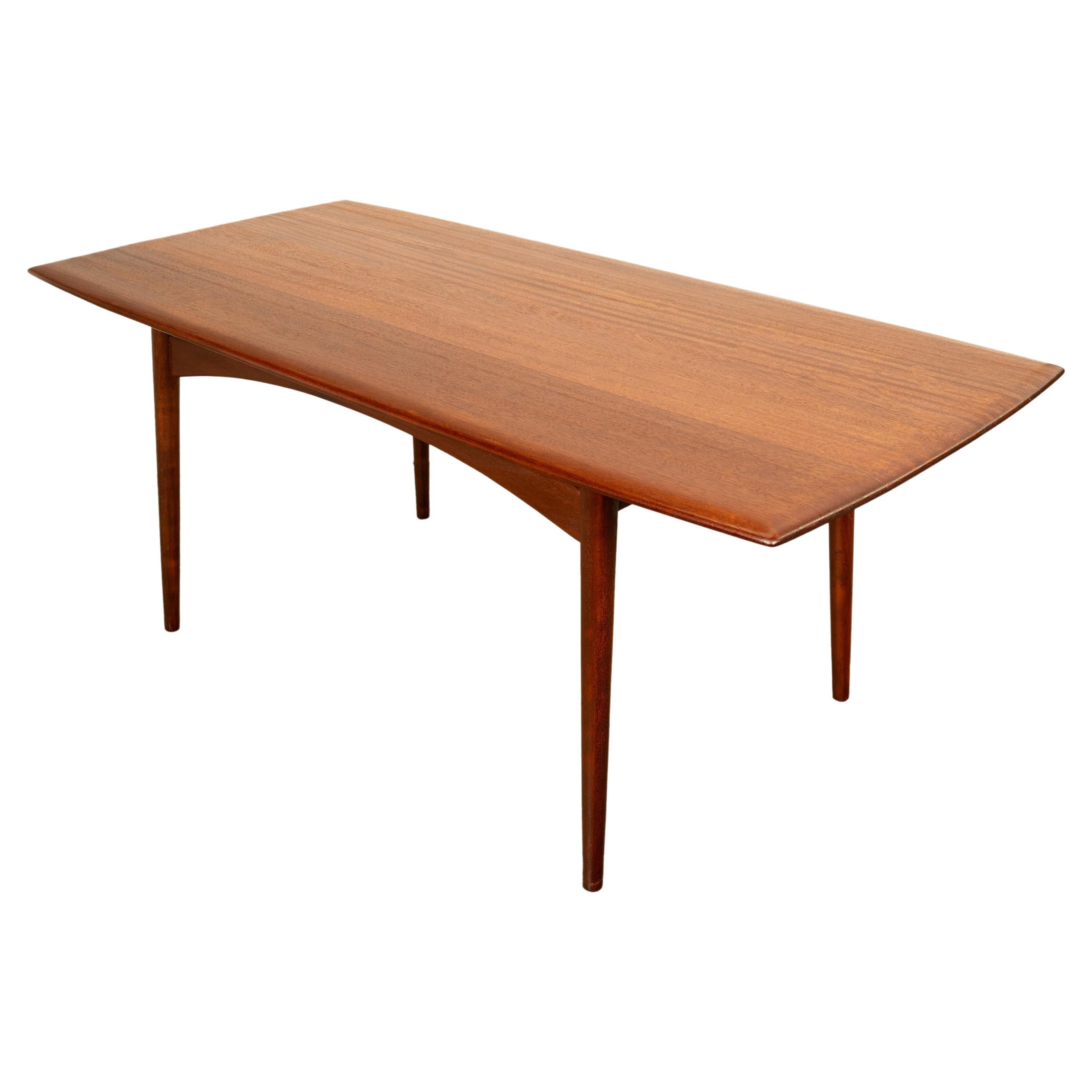A very good Mid Century Modern Afromosia teak dining table, 1960.
This very stylish MCM dining table is made from solid Afromosia wood (referred to as African teak). The table was designed by Malcolm David Walker for the family firm known as
