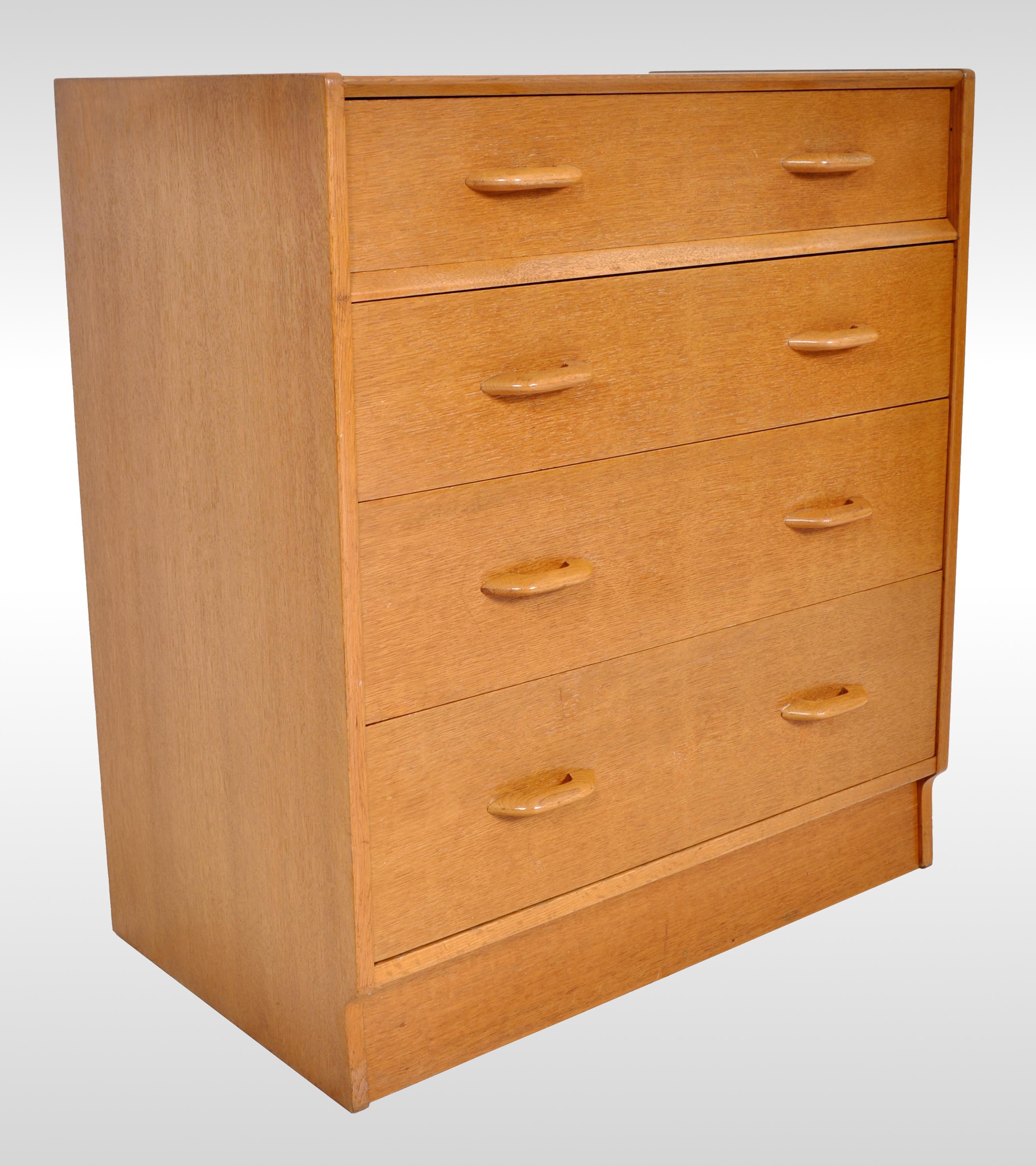 Mid-Century Modern Danish style teak chest of drawers / dresser by G Plan, 1960s. The dresser having four graduated drawers and standing on a plinth base. This chest of drawers is one of the early production models by G Plan and bears the gold 