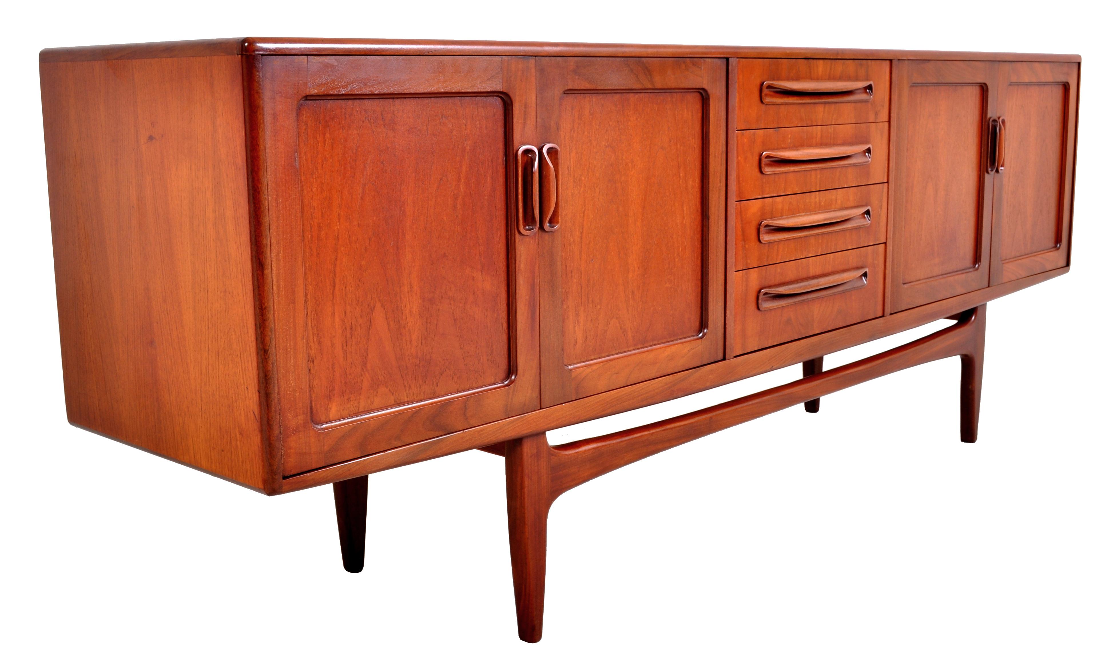 Mid-Century Modern Danish style teak Fresco credenza by G Plan, 1960s. The credenza having a central bank of four graduated drawers flanked by cupboards with two doors to either side. The credenza having a stretcher below and raised on tapered legs.