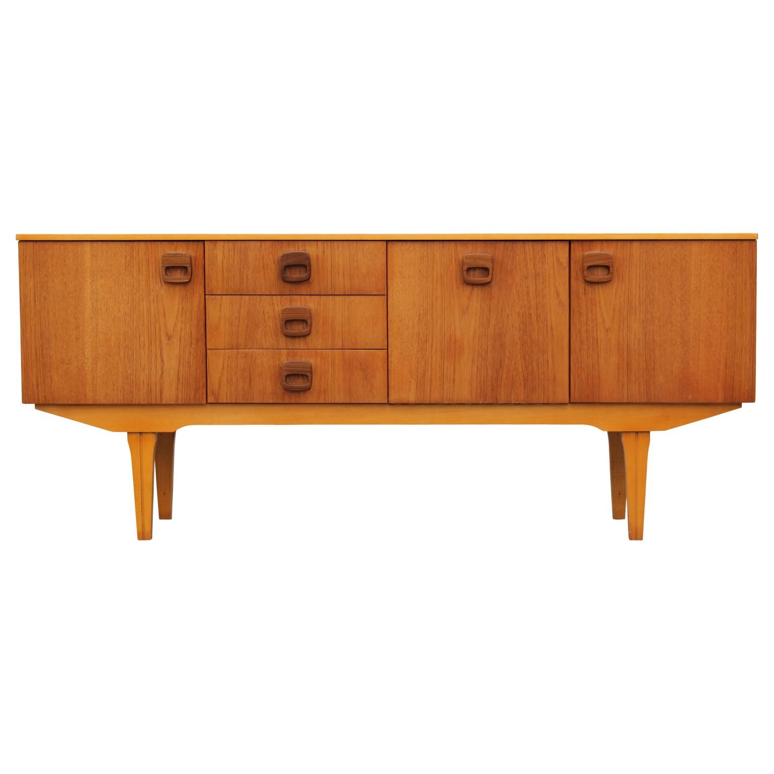 Beautiful modern Danish style teak sideboard or credenza with wooden ring handles, circa 1960s.