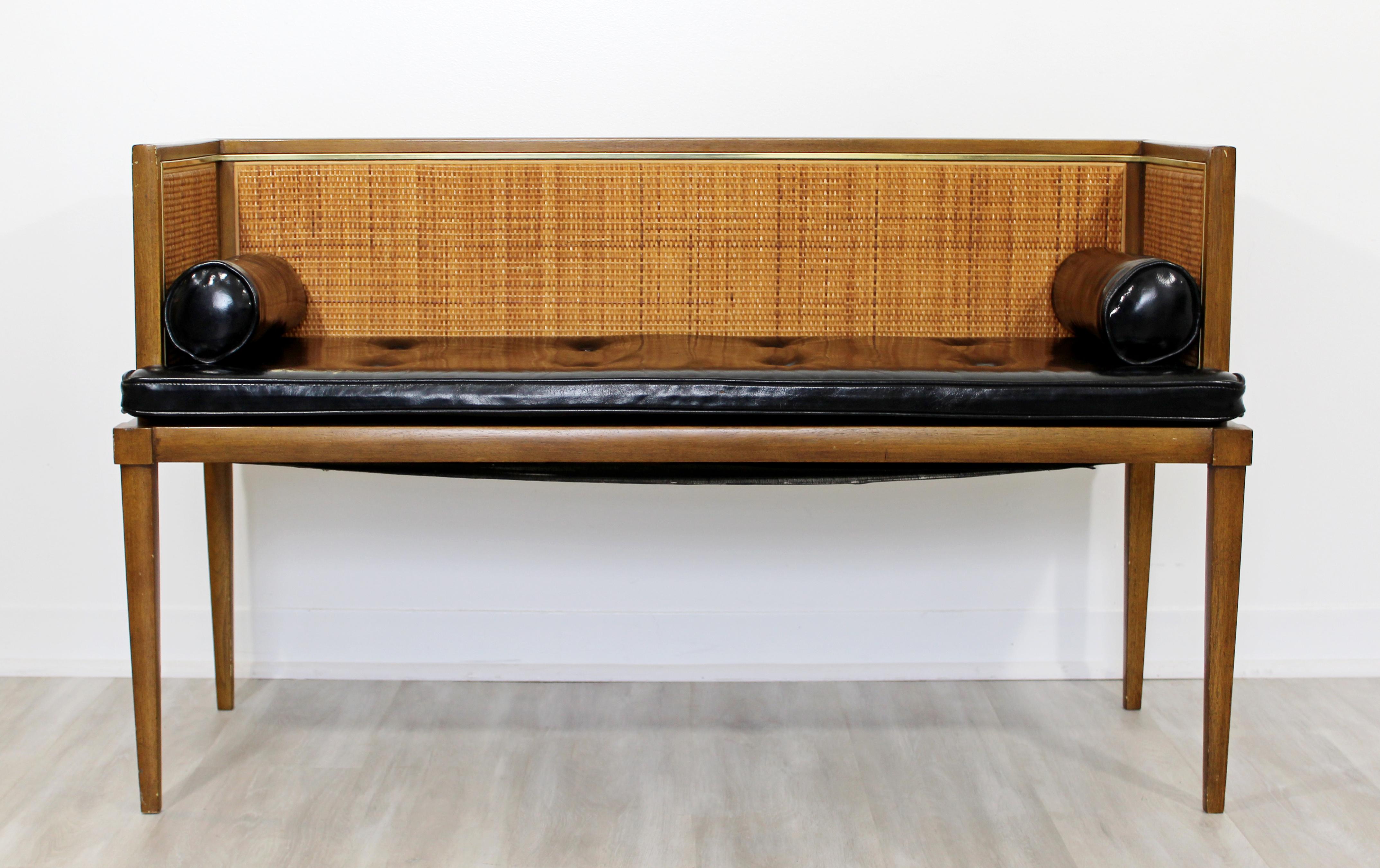 For your consideration is a remarkable, Danish style window bench seat, with a wood frame, cane back and arms, leather seat and brass accents, circa the 1960s. In very good vintage condition. The dimensions are 47