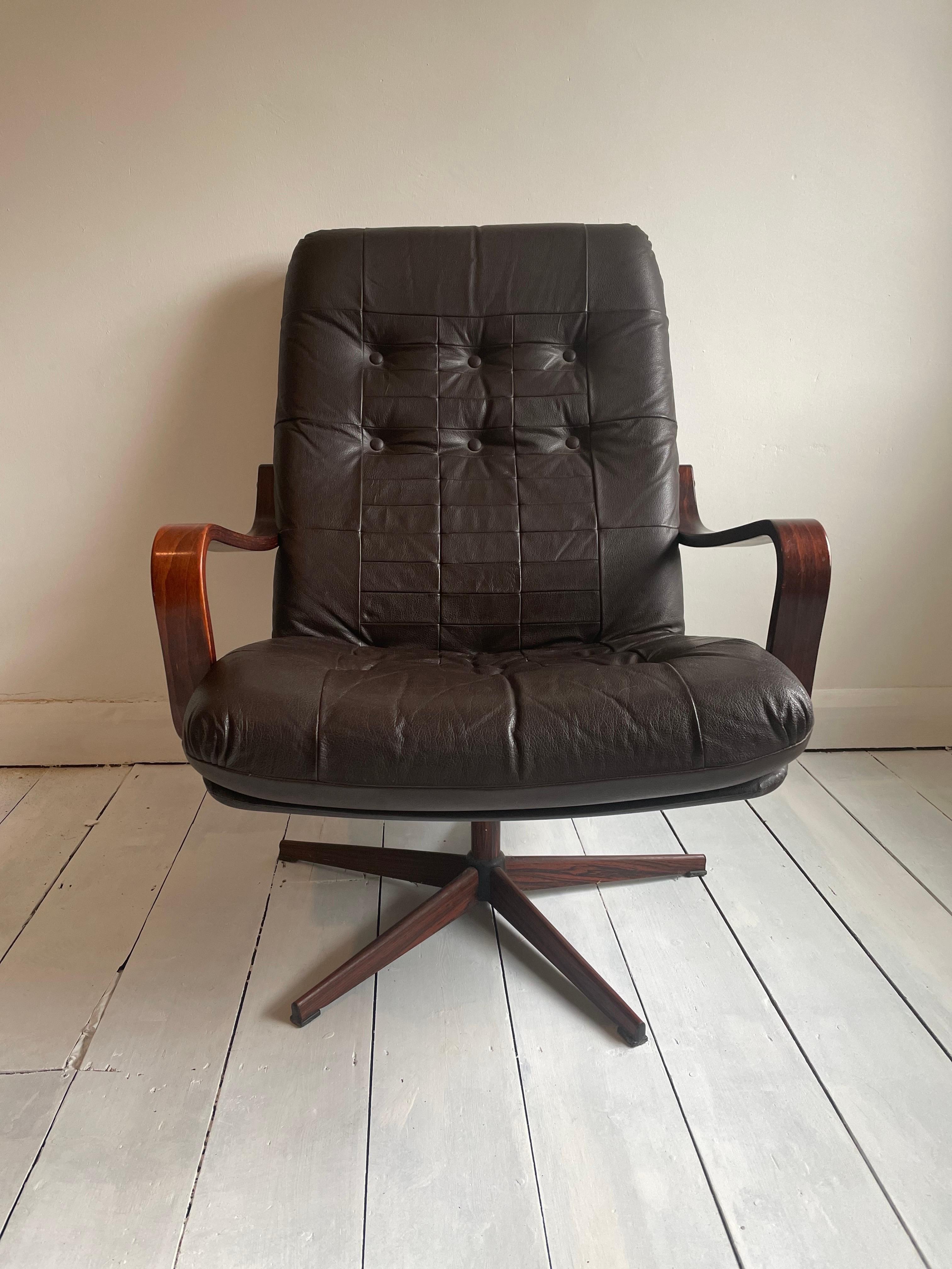 1970s, Scandinavian design. Swivel chair five-star base. Dark brown. Original very good condition:  Manufactured by Swedish or Danish furniture manufacturer in about 1970s. This handsome swivel chair  is in superb vintage condition and good to go