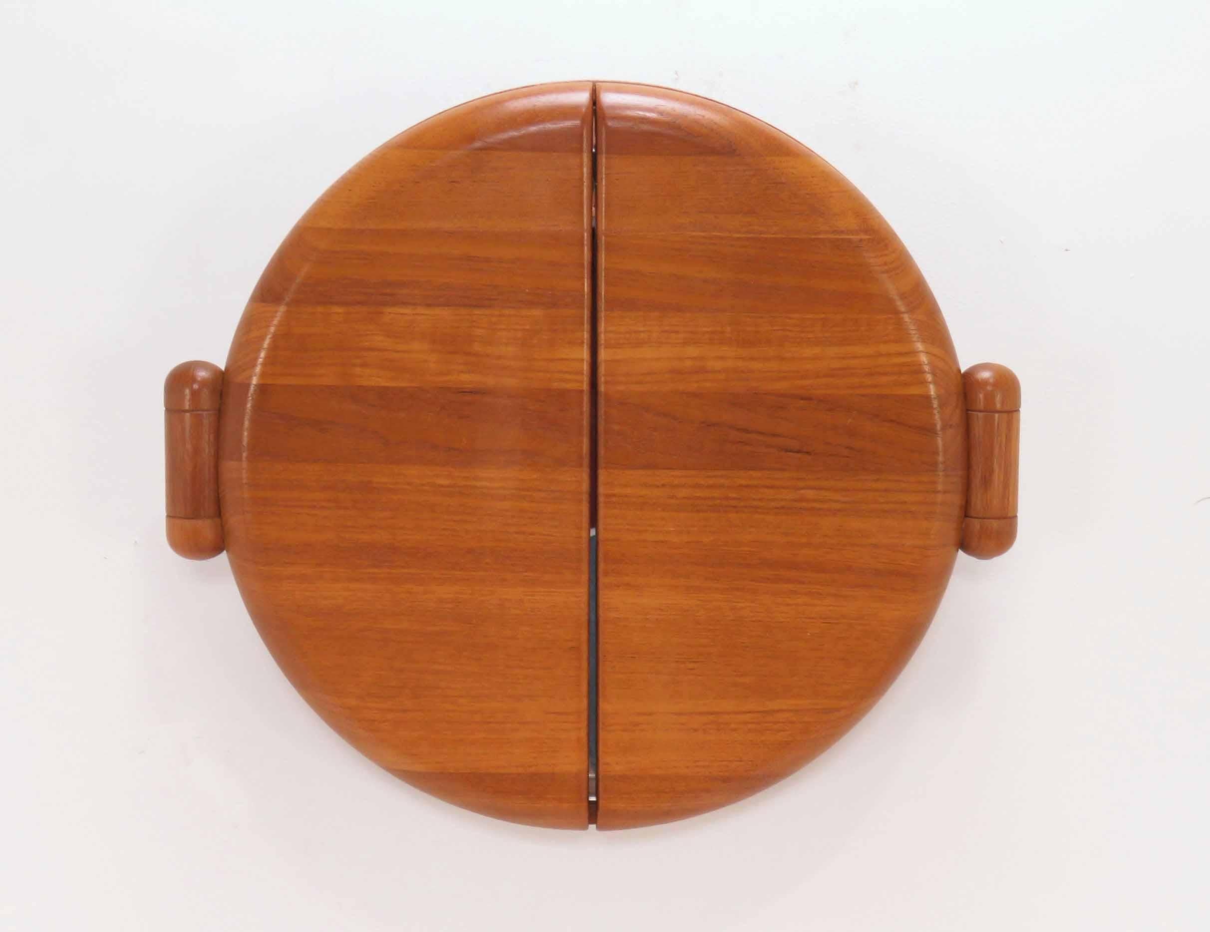 Danish teak adjustable tri-fold wall mirror with hinged side panels. When closed, this makes an interesting wall sculpture, circa 1970s. In the style of Pedersen & Hansen, Denmark.

Center mirror is 19.5