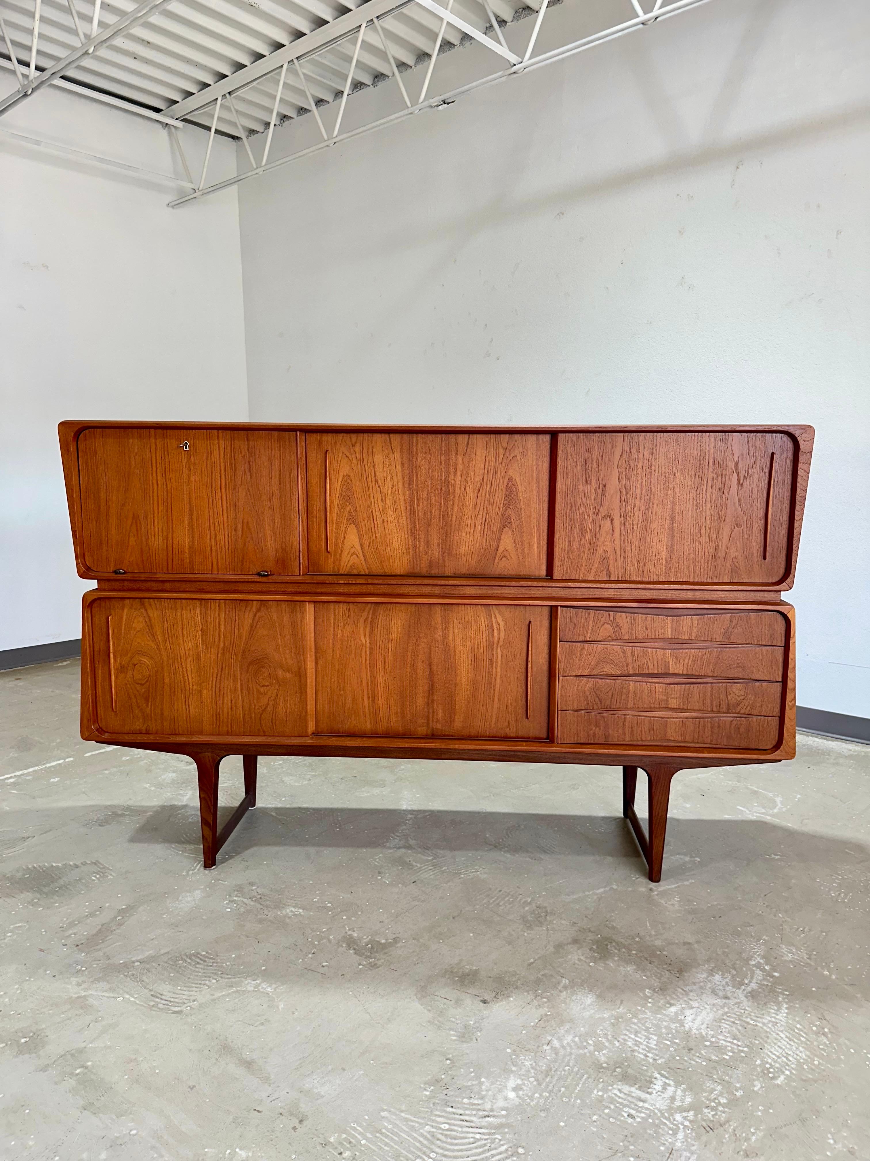 Mid Century Modern Atomic 1950’s Danish Teak Sideboard attributed to Salling Stollefabrik. A statement piece rarely seen in the US, top and bottom sections have unusual angular lines. 73”W x 46.5”H x 18.5”D

Top section features a locking drop down