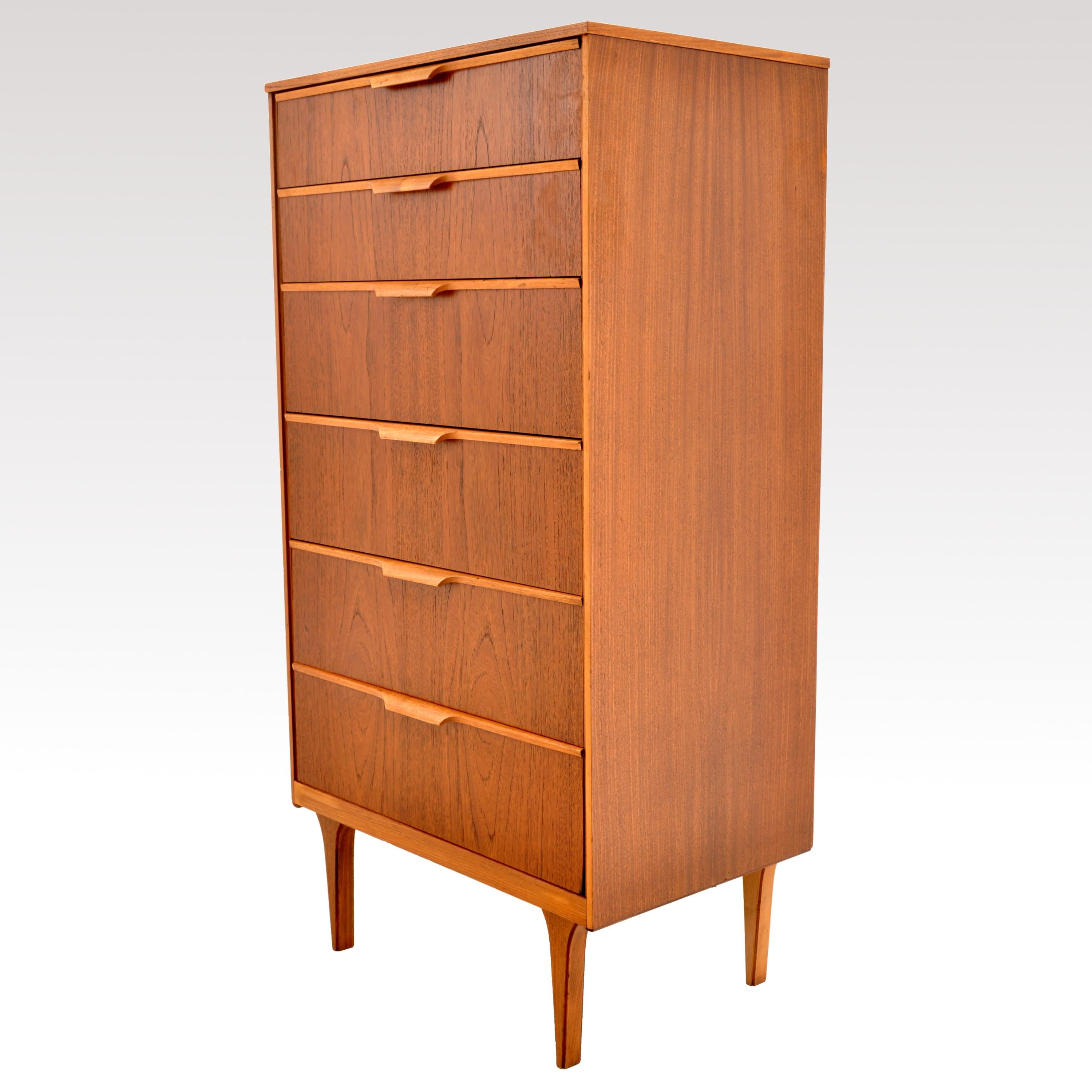The dresser having six graduated drawers with turned pulls and standing on tapering legs.