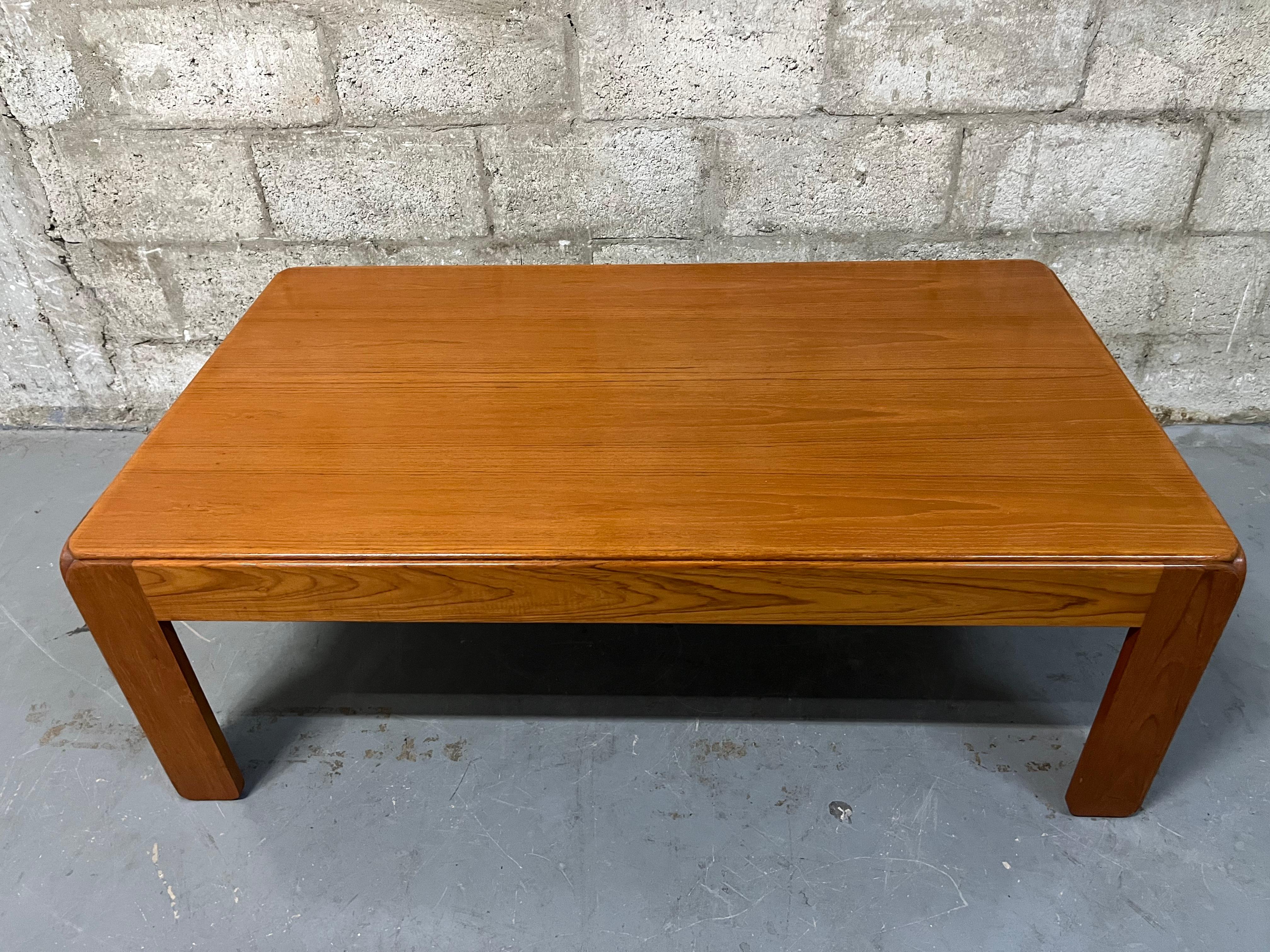  Vintage Mid-Century Modern Danish Teak Coffee Table by Niels Eilersen. Circa 1970s
Features a sleek Mid-Century Modern Scandinavian design, with rounded corners, and a beautiful teak wood grain. 
In excellent original condition with minor signs of