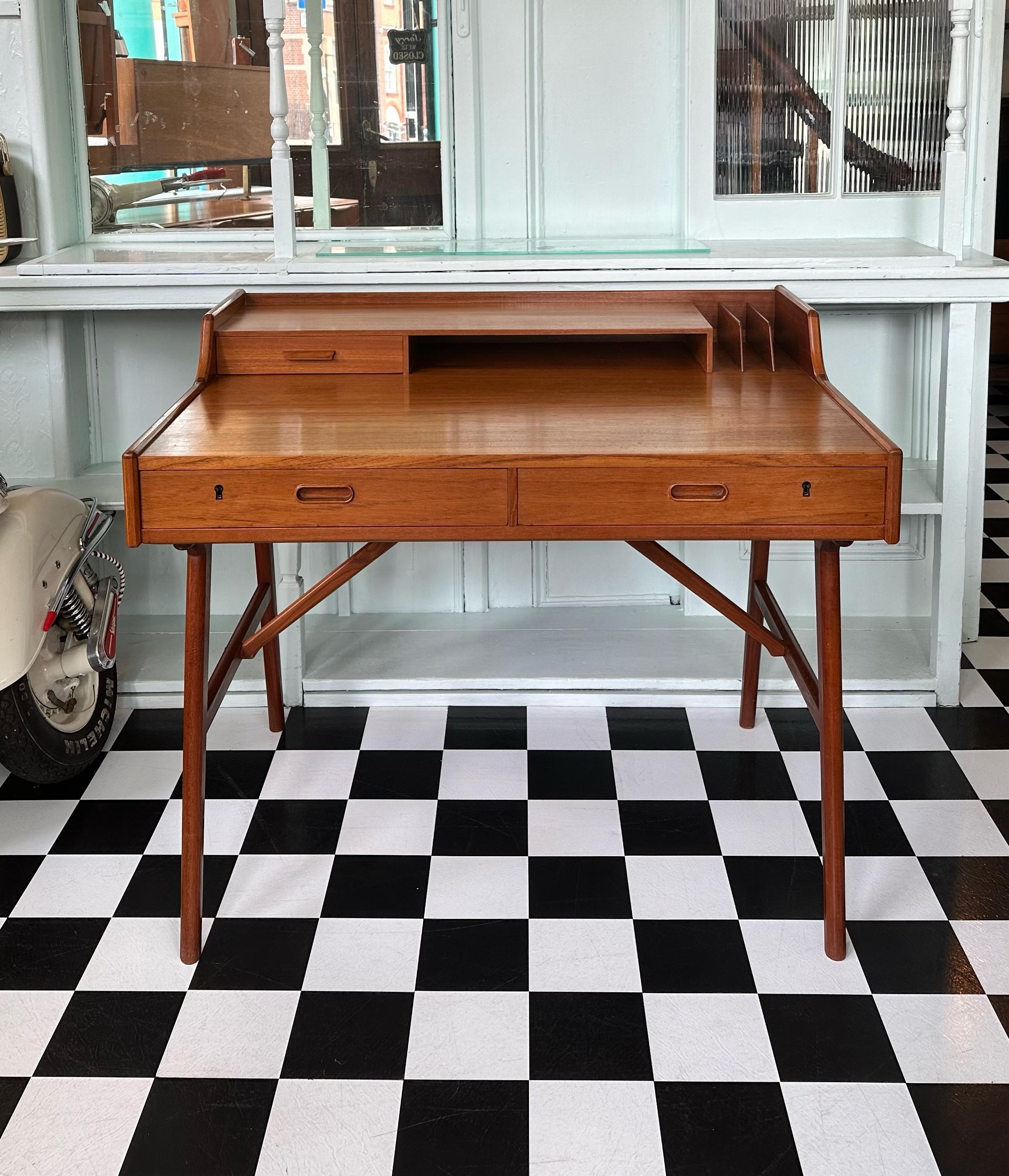Fabulous and super stylish mid-century Danish teak desk. It was designed by Arne Wahl Iversen (Model 56) for Vinde Møbelfabrik in the 1960’s. Beautifully made top quality piece. Great size with good amount of storage. Features two drawers with