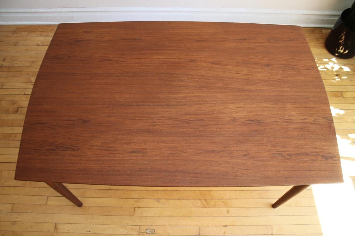 Scandinavian Mid-Century Modern teakwood expanding dining table.
Just imported from Denmark!
Refinished table with curved self-storing leaves on each end.
Chairs not included but they are also available.
Seats up to 10 people comfortably.