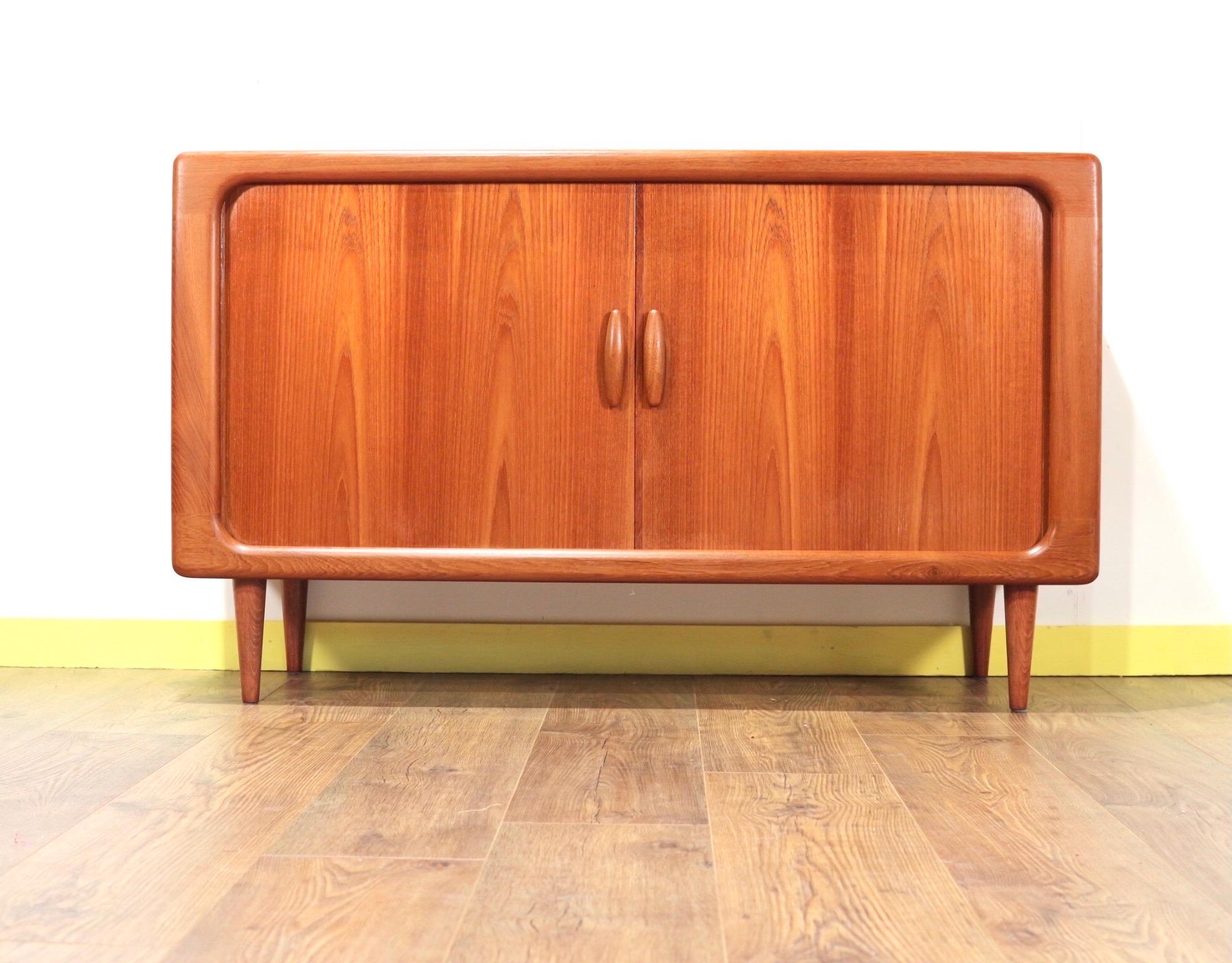 This gorgeous cabinet made by Danish furniture maker Dyrlund is a truly stunning piece. With its tambour doors and striking design it is a true statement piece. Originally used as a drinks cabinet it could have a variety of uses. It would look