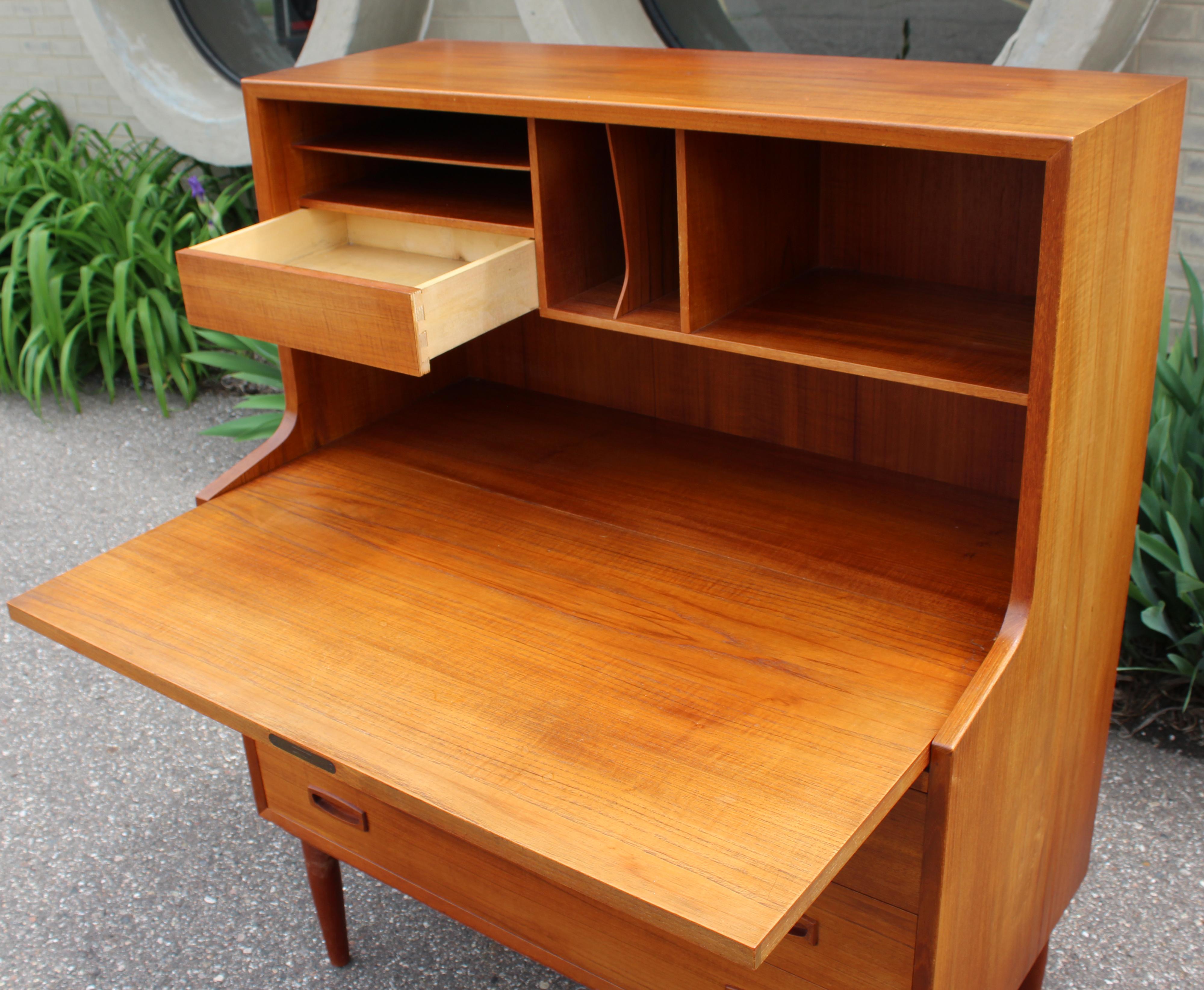 For your consideration is a magnificent, teak drop down desk secretary dresser made in Denmark, circa the 1960s. In excellent vintage condition. The dimensions are 35.5
