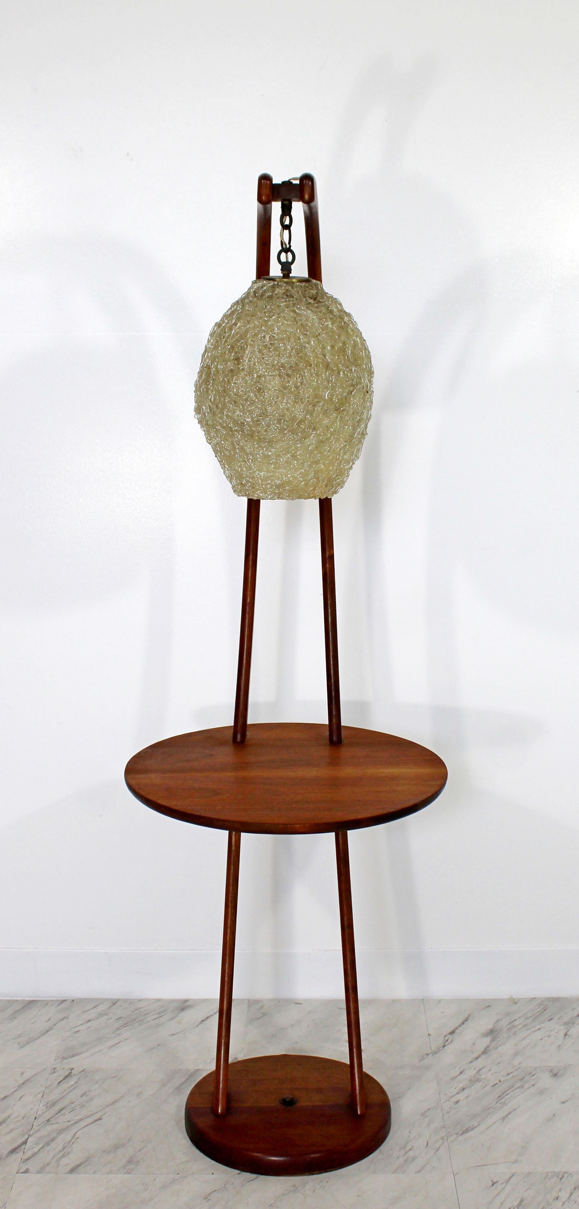 For your consideration is a magnificent, curved teak wood, floor lamp table, with a hanging, spaghetti resin shade, circa 1960s. In very good condition. The dimensions are 18
