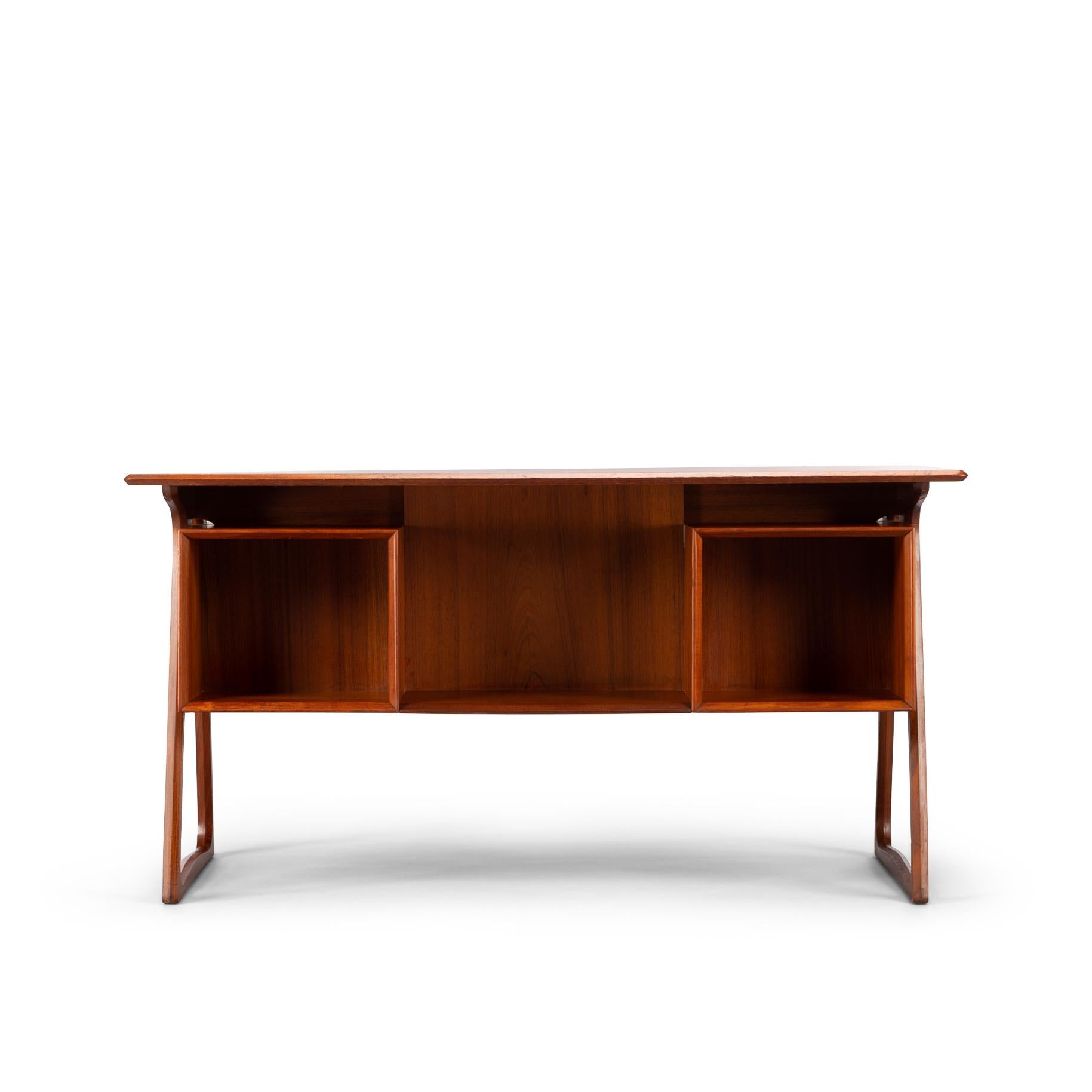 This desk in teak of which the manufacture is attributed to Sibast møbler is of simple yet elegant and functional design. Most pronounced are the sides of the desk which are delta shaped and uphold the drawer blocks with three drawers each and the