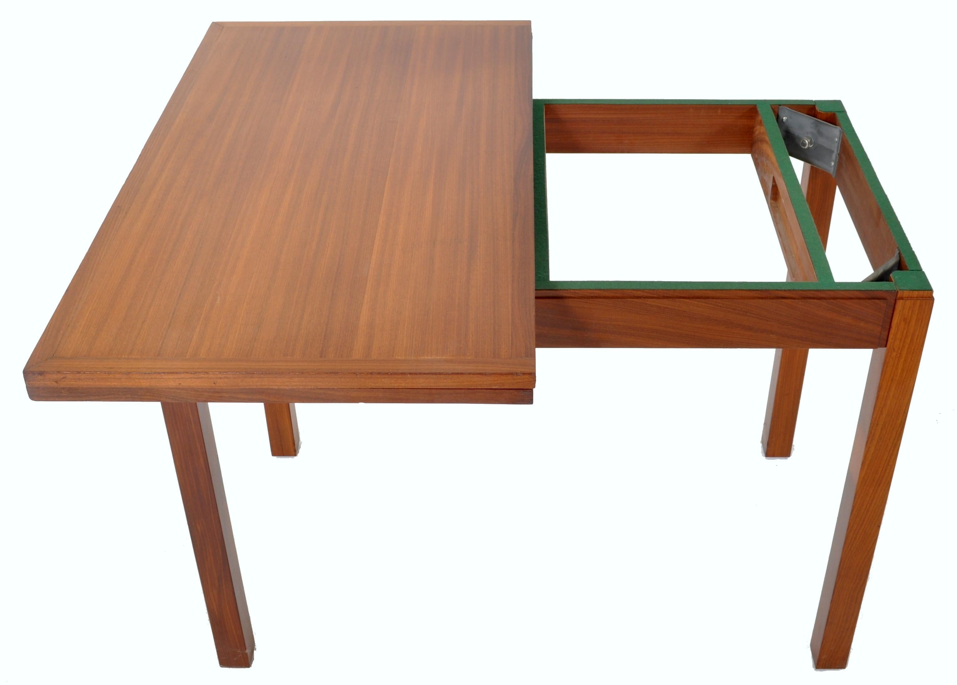 A good quality Mid-Century Modern Danish teak games/card table, 1960s. The table having a fold-out leaf that turns to reveal an inset green baize/felt playing surface, the table raised on square legs.