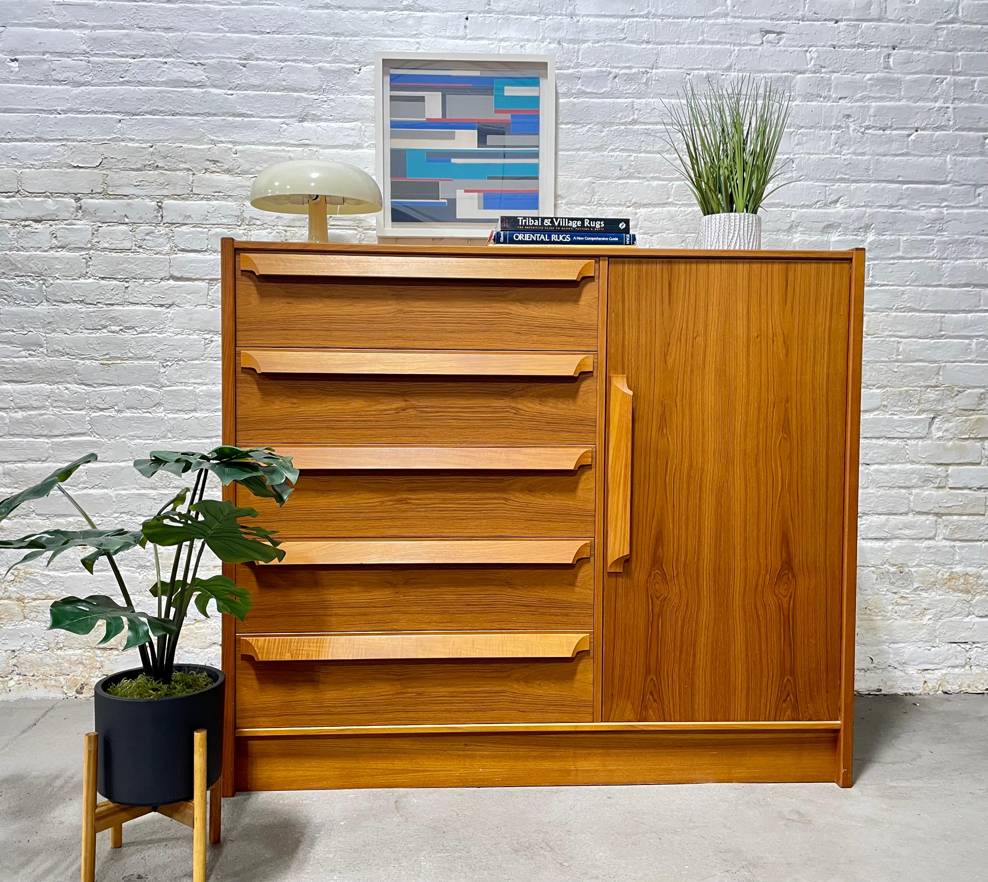 Sculpted Mid-Century Modern Danish teak gentlemen's chest by Skovby Mobelfabrik. This gorgeous armoire features loads of storage space in a thoughtful combination of drawers and shelving space. Constructed in teak with lovely wood grains and solid
