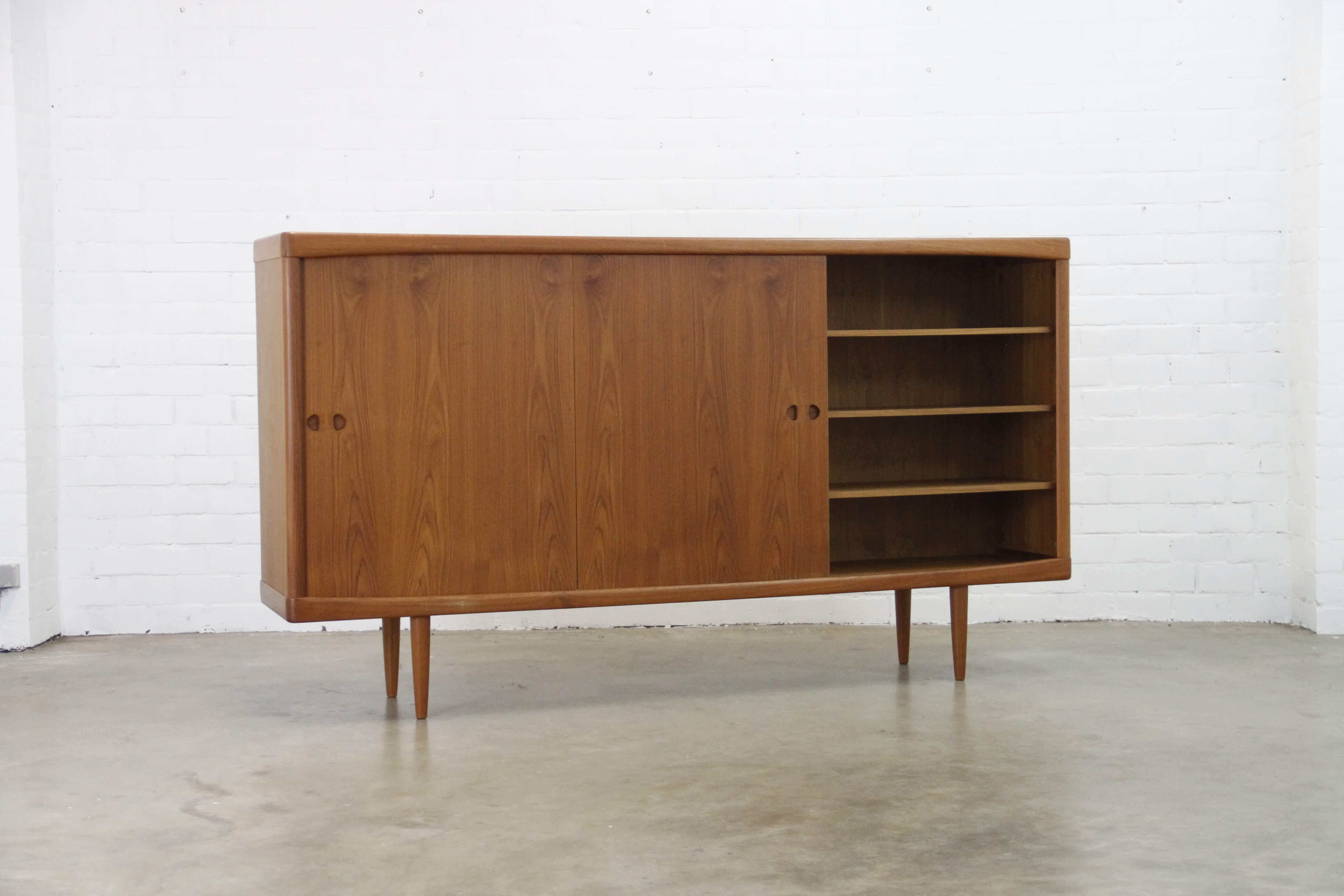This highboard was designed by Henry W Klein for Bramin, Denmark.
There are two sliding doors, four drawers and a swing door with a bar section.
The highboard is of very high quality and in very good condition.
Finished in teak.