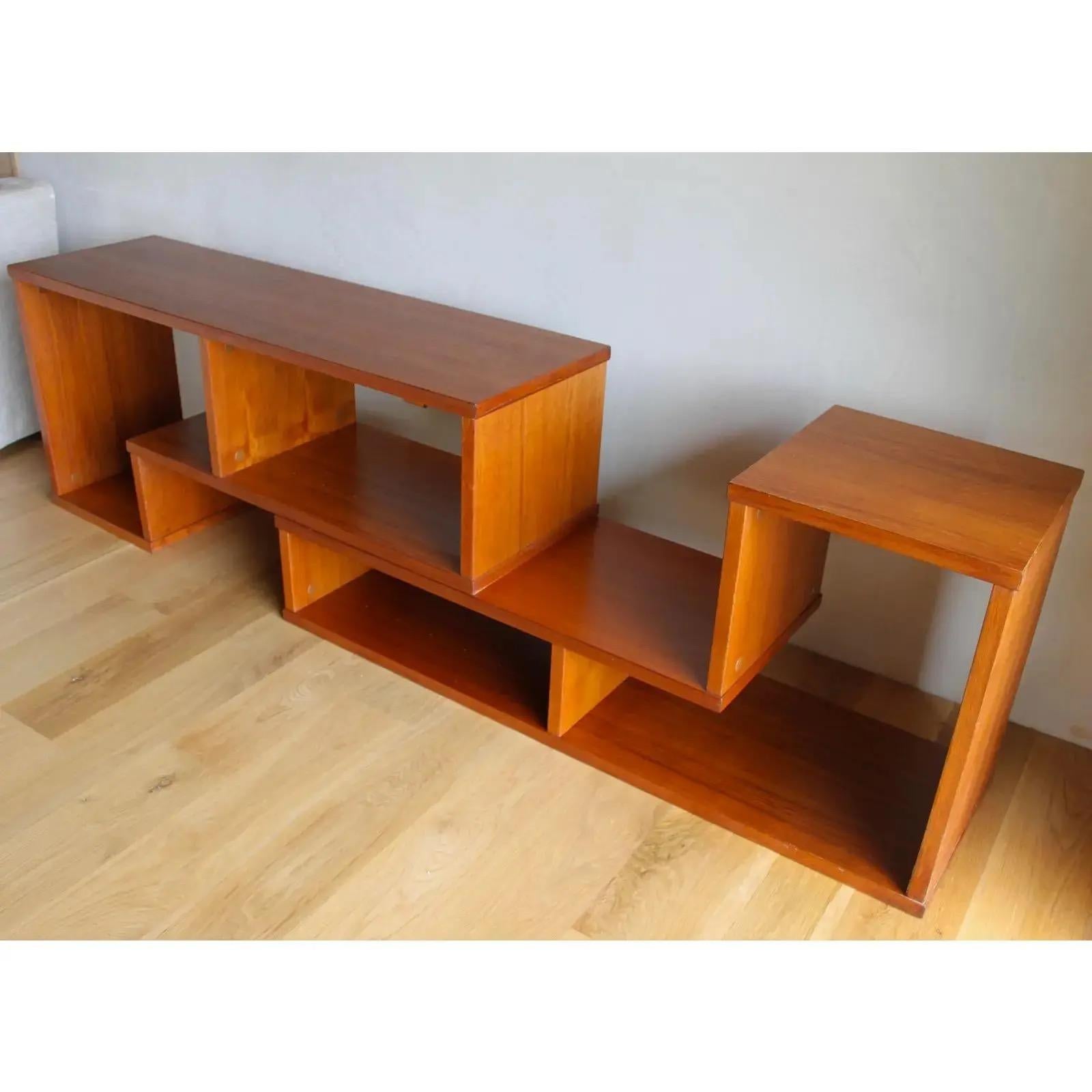 Gorgeous, heavy and well-made geometric interlocking Danish teak shelving units that can expand and contract to fit many spaces and needs.
The modular design ensures usefulness, longevity and spatial fit in any size space and design scheme. 
Each