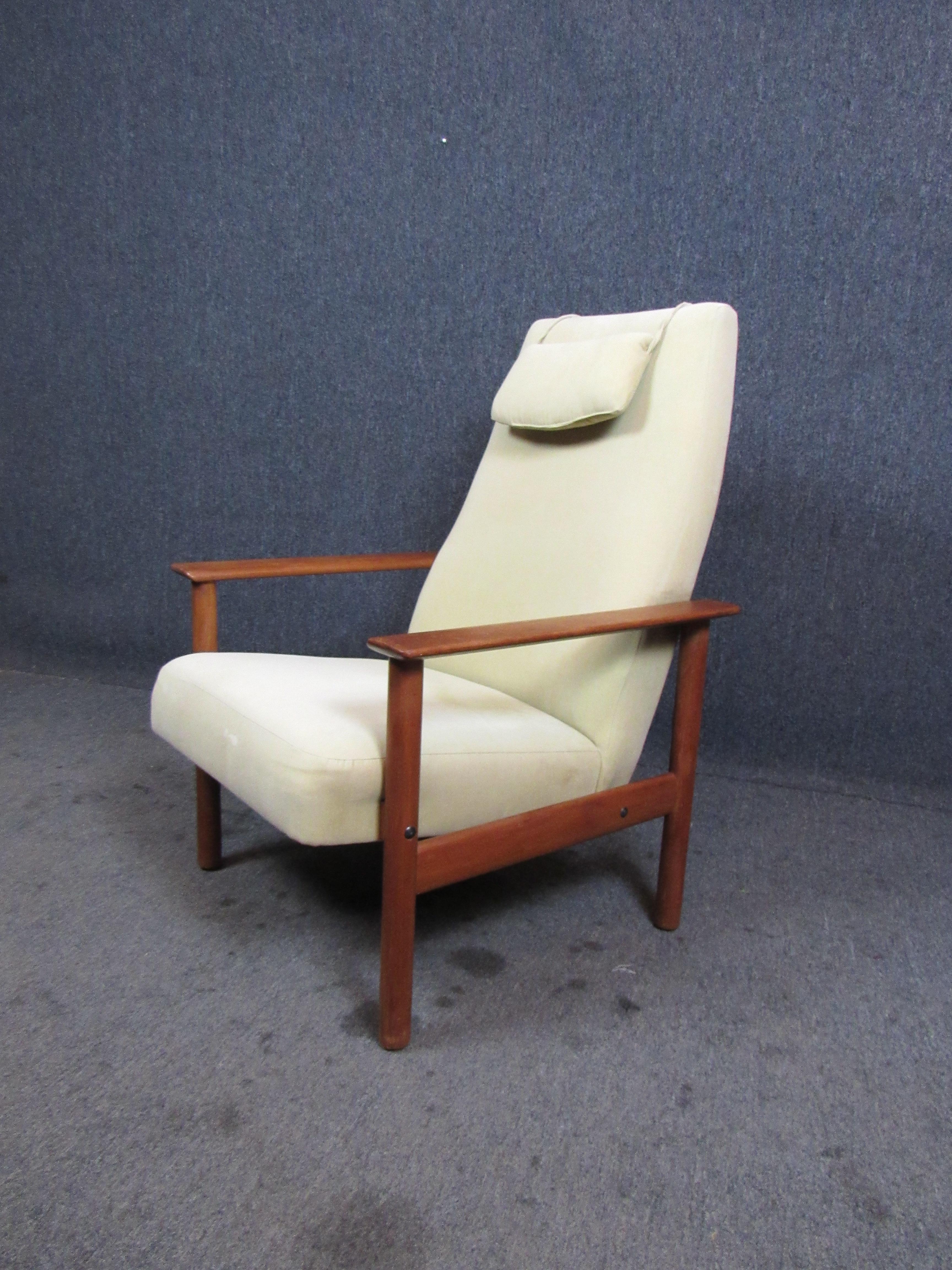Terrific Mid-Century Modern vintage Danish lounge chair. A sturdy teak frame supports ample plush cushions for a wonderful sitting experience. The included pillow provides additional comfort for the neck and head. Please confirm item pickup location