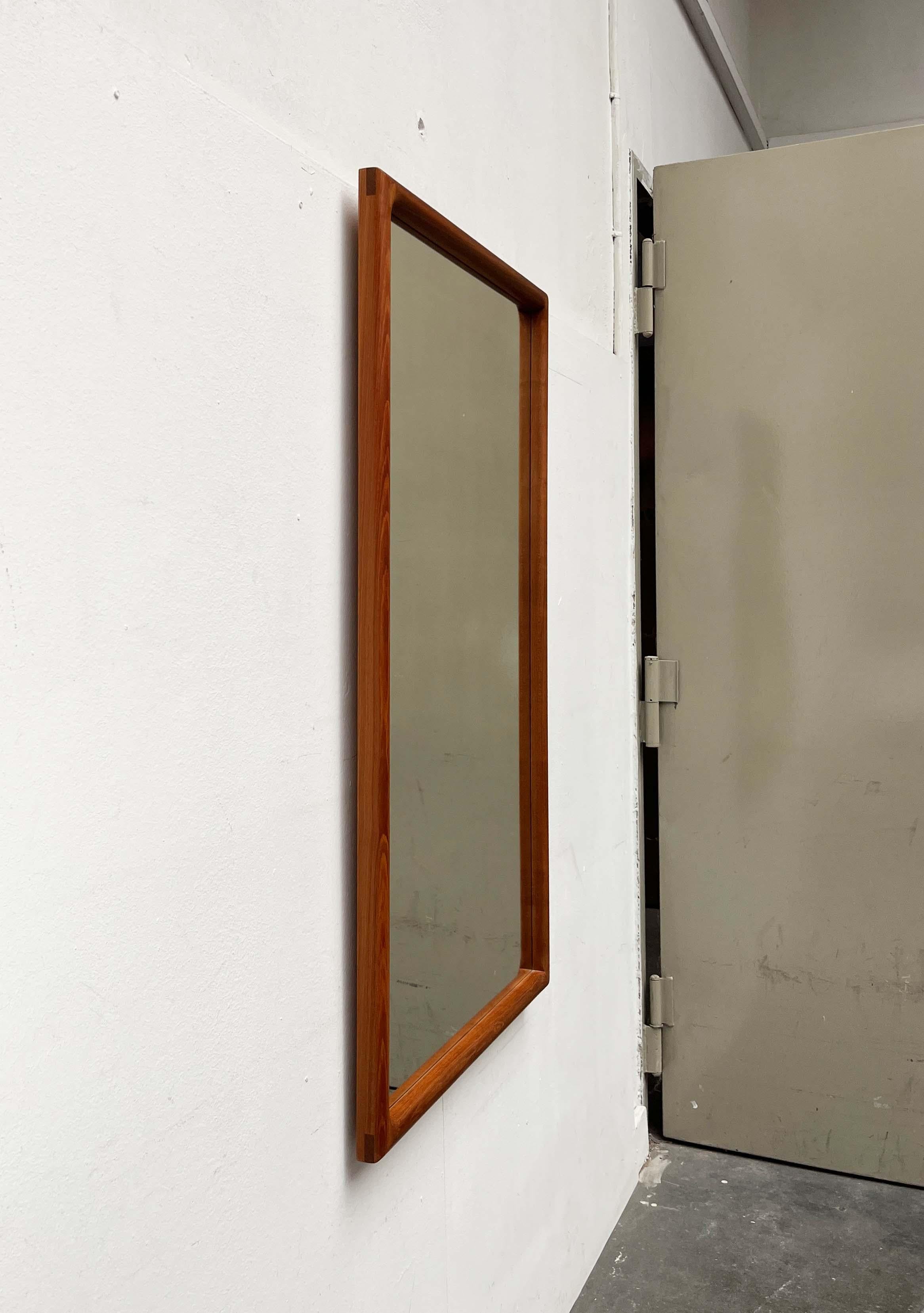 Specchio classico in teak della Vildbjerg Møbelfabrik, forse basato su un disegno di Kai Kristiansen degli anni '60.

Grande specchio da ingresso con un'elegante cornice in teak massiccio. Il design angolare degli elementi in legno massiccio con i