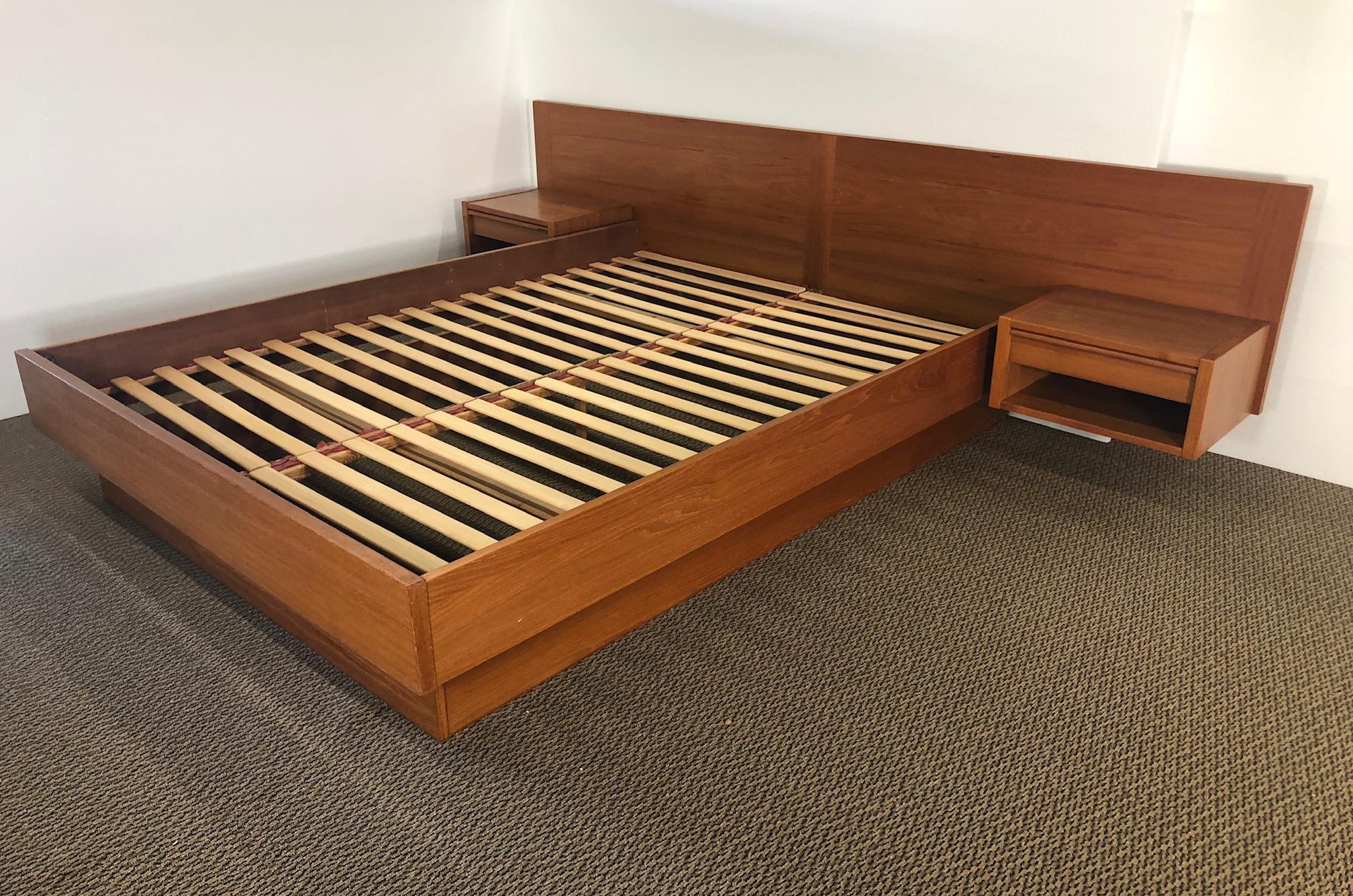 This is an amazing midcentury queen size teak platform bed. The bed features floating nightstands with drawer.

Very good vintage condition. A ring mark on one night stand and some spots on the other. Chip on handle on one drawer. See last photo.