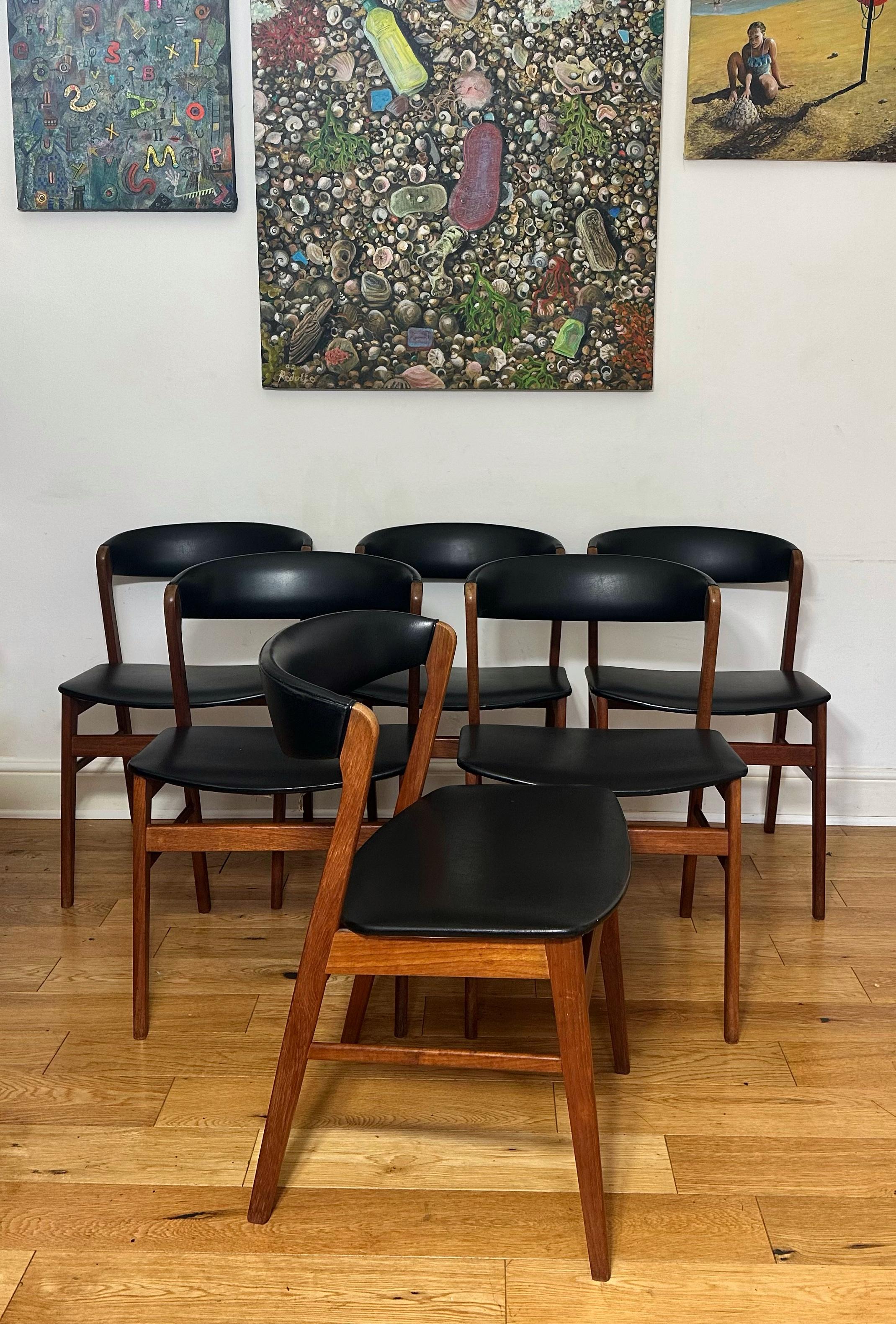 Stunning Mid-century modern Danish set of six dining chairs by Sax. Solid teak frame, very sturdy. The seats are covered in the original black vinyl which is in great condition. Beautifully designed with rich teak grain throughout and angled frame.