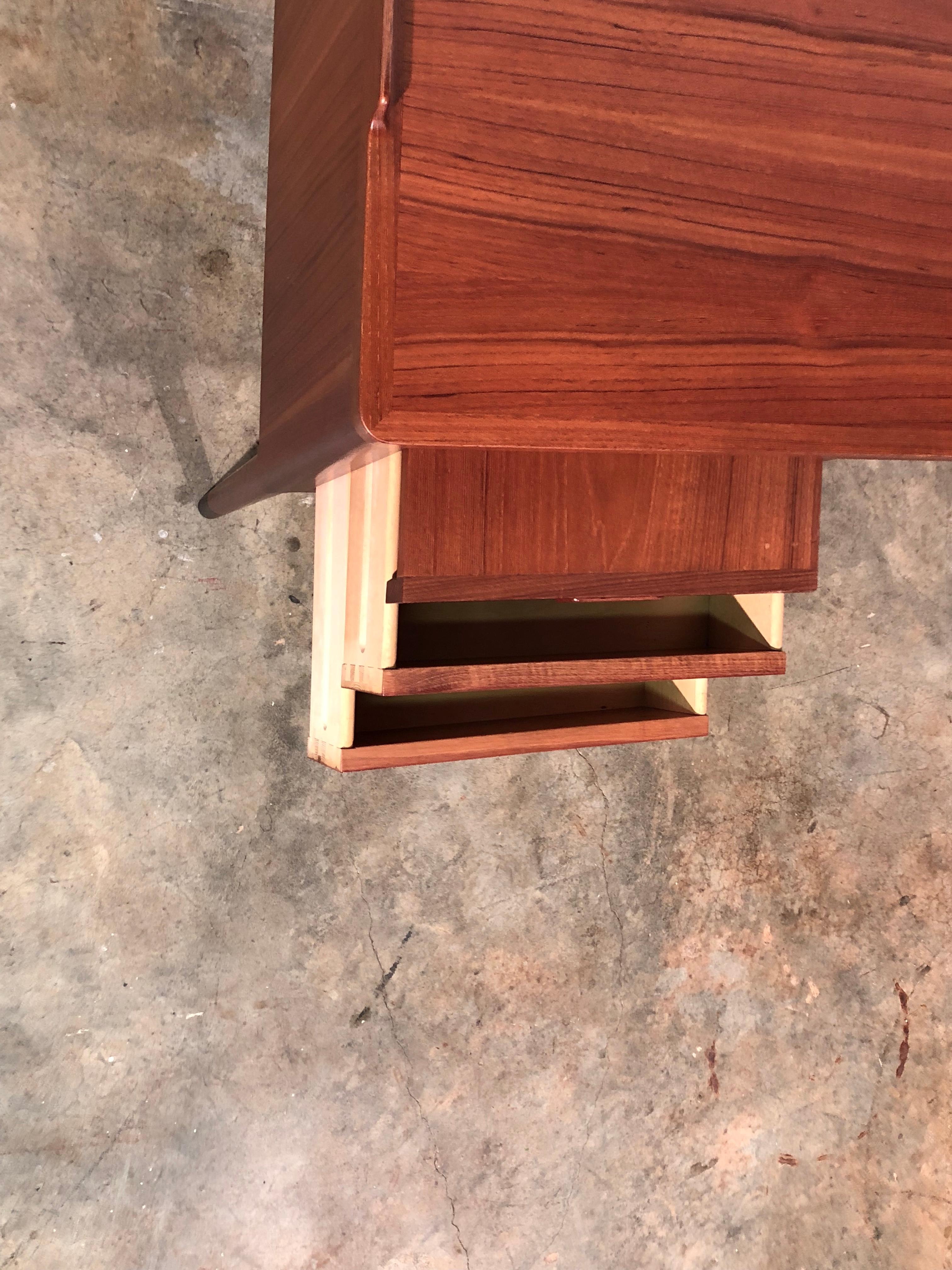 Mid-Century Modern Danish teak slant front desk with built in wine bar. Great Danish design featuring a rotating hideaway wine cubby along with a inset shelf for books or décor. No key for the lock.
No other known issues that would detract from