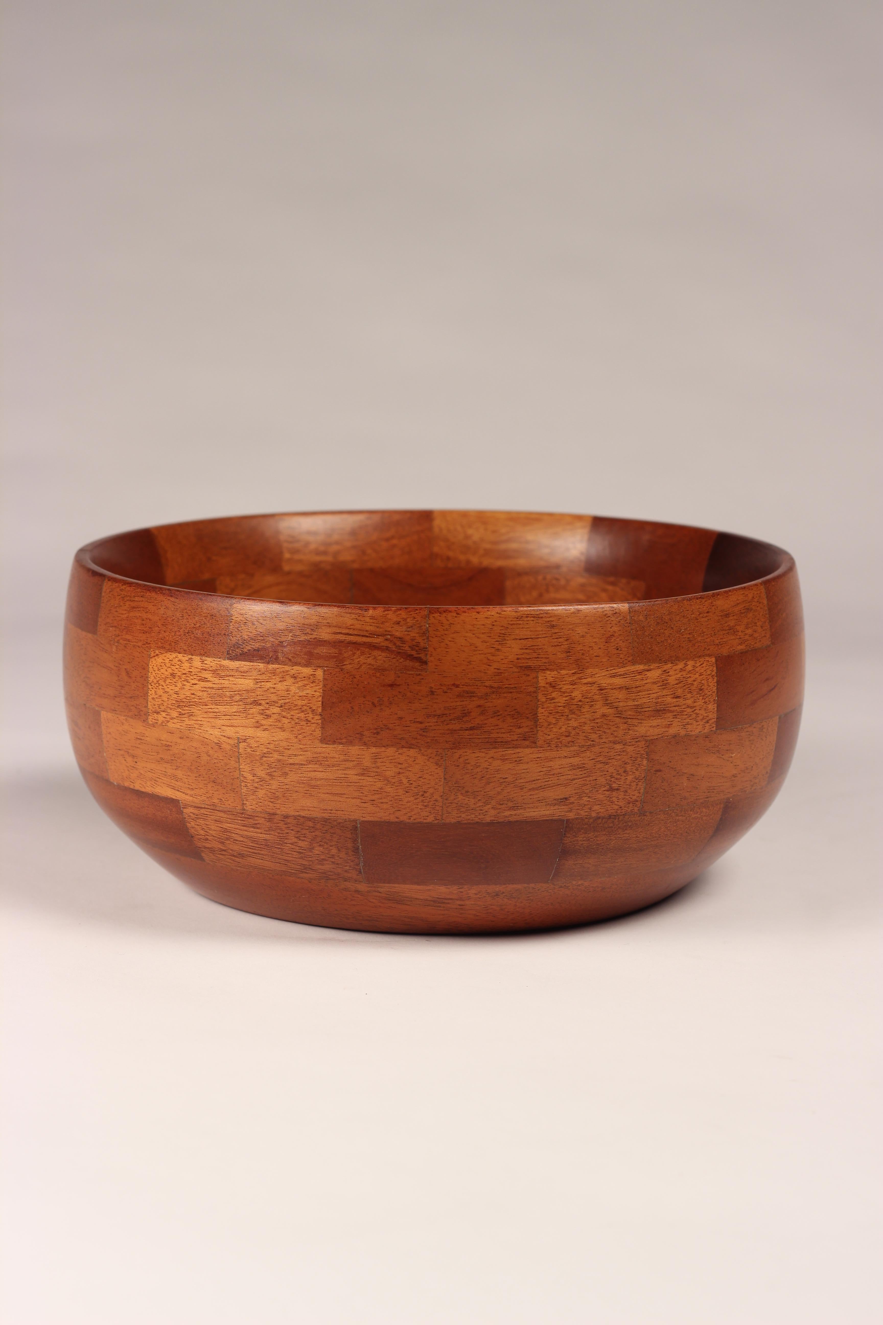 Scandinavian staved and turned teak bowl of good proportions. It has been re oiled and wax polished, with a new felt base cut.