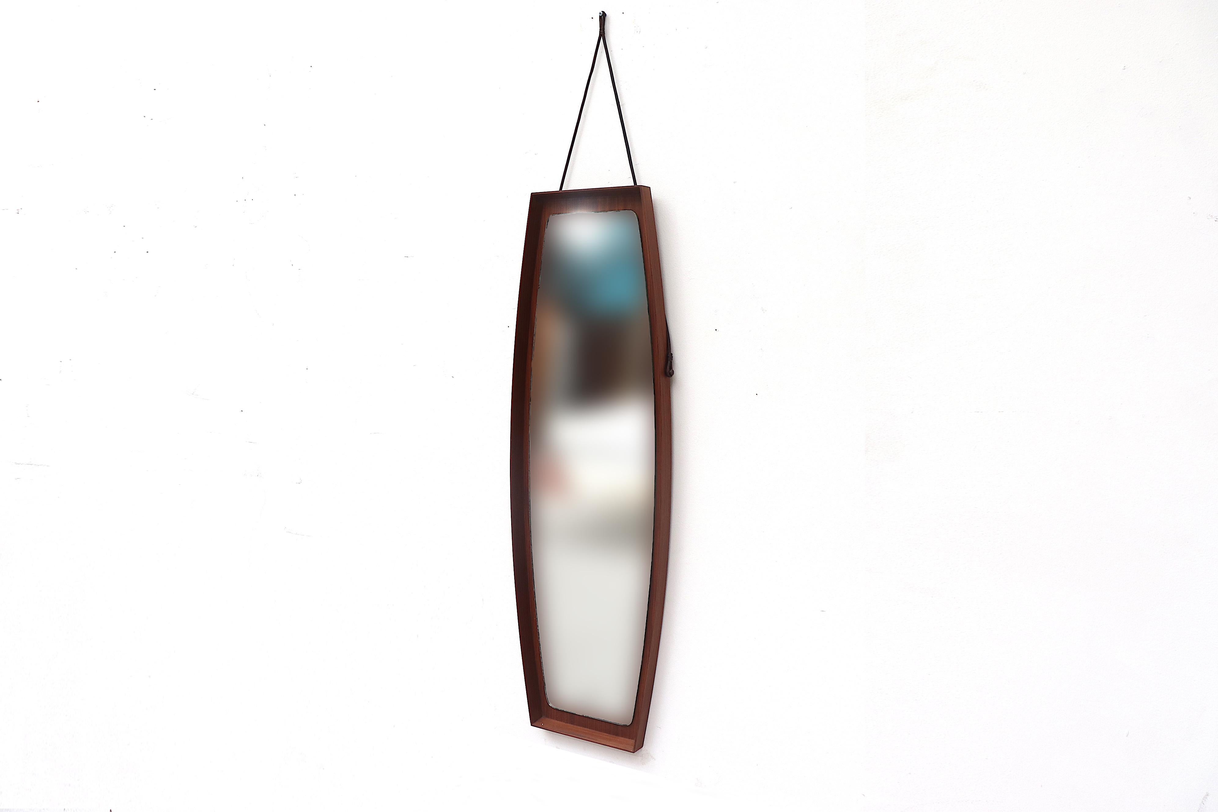 Midcentury wall mirror with teak frame and Leather strap. Mirror measures 47