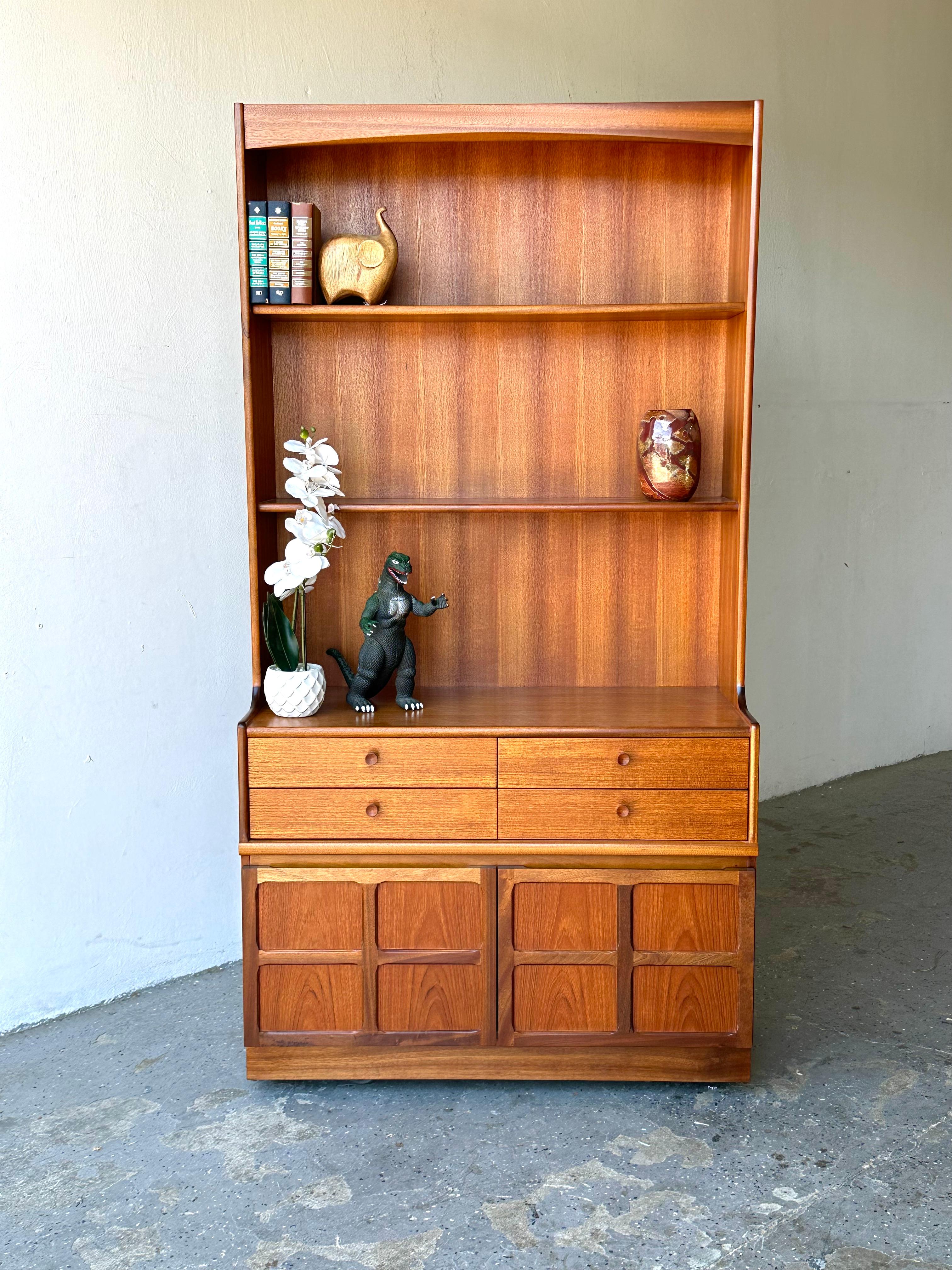 Mid-Century Modern Danish Teak Wall Unit,  Bookcase , Hutch by Nathan Furniture

 Danish Modern  Teak Wall Unit/Bookcase/Hutch by Nathan Furniture, 1960s. The cabinet having a back with twin shelves, the base having a bank of four drawers with two