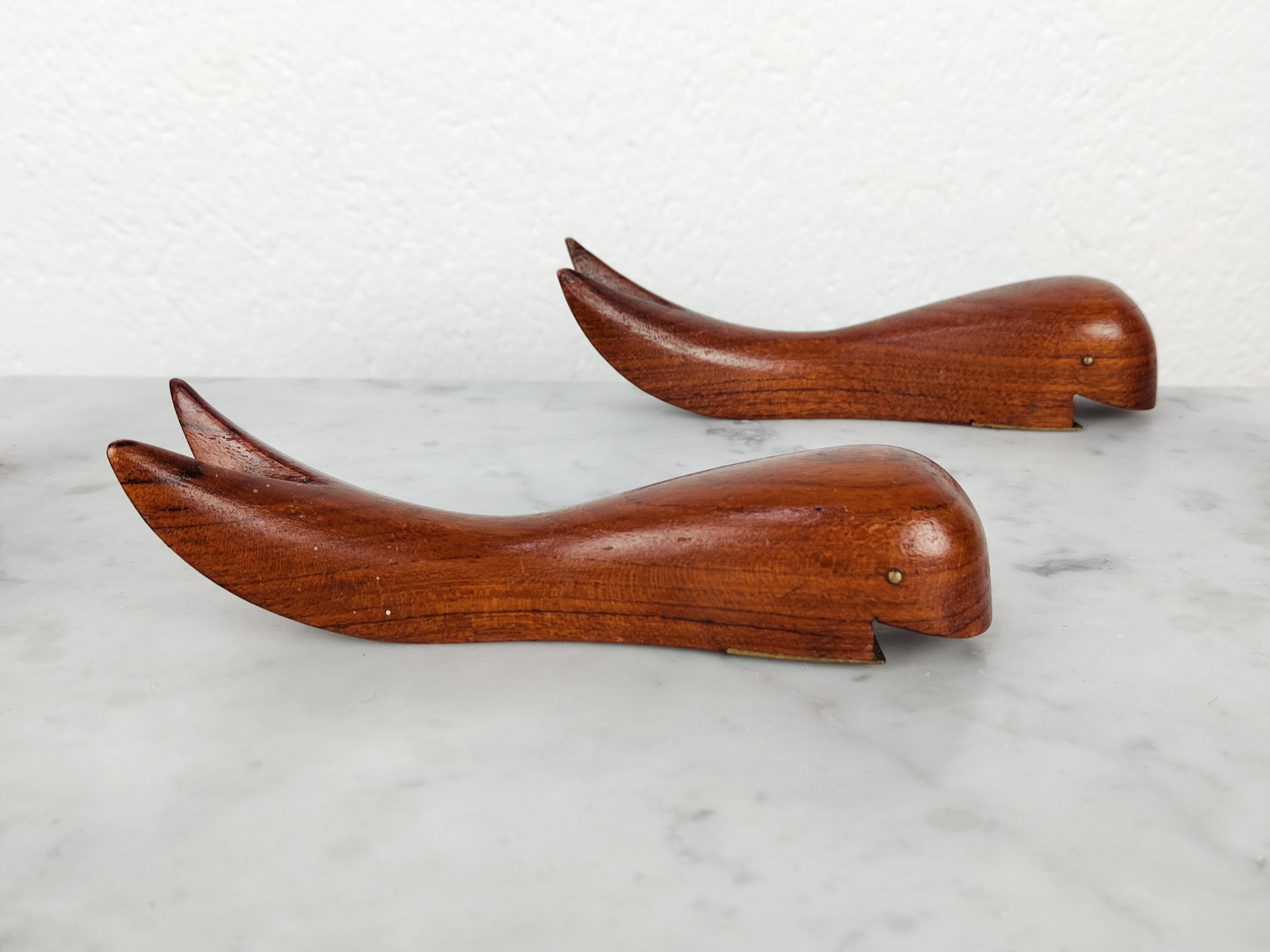 In this listing you will find Danish Mid Century Modern bottle openers made of teak wood. They feature shape of the whale, with brass details as their mouth used to open the bottles. Exquisite and very elegant craftsmanship. Good vintage condition